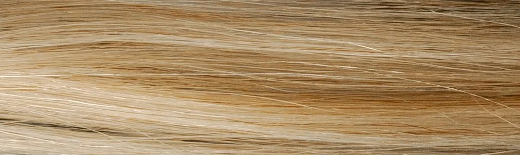 Close-up of blonde hair with straight strands.