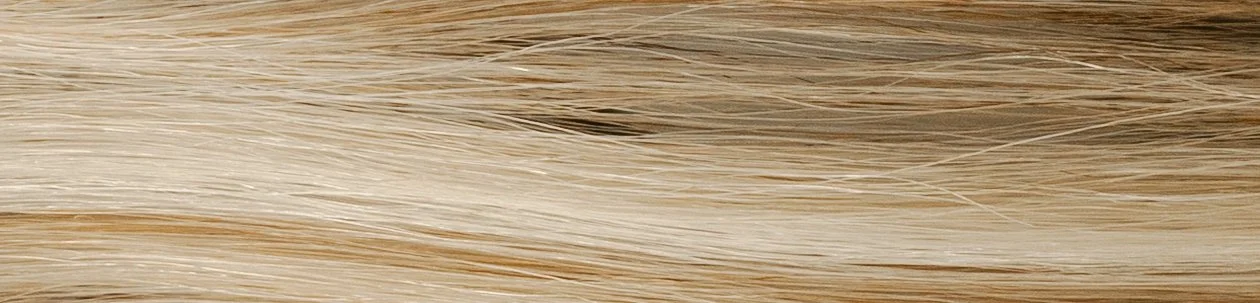 Close-up of light-colored wooden surface with visible wood grain.