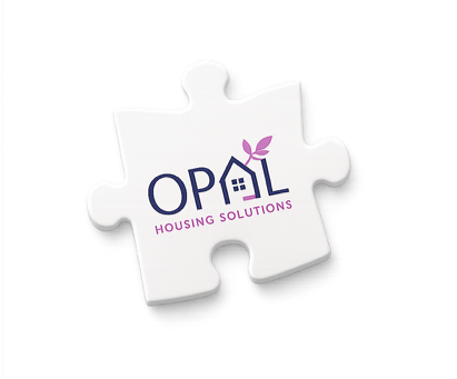 A white puzzle piece with the OPAL Housing Solutions logo, featuring a house with a small plant, and the text 'OPAL Housing Solutions' in blue and pink.