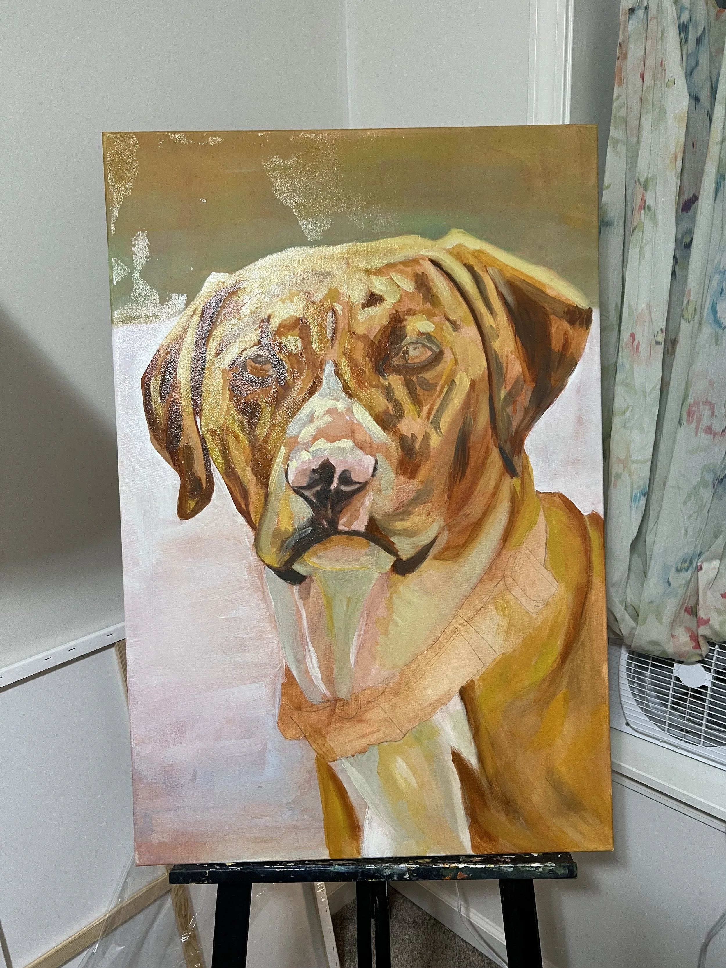 A painting of a brown and tan dog with a pink nose and droopy ears on an easel.