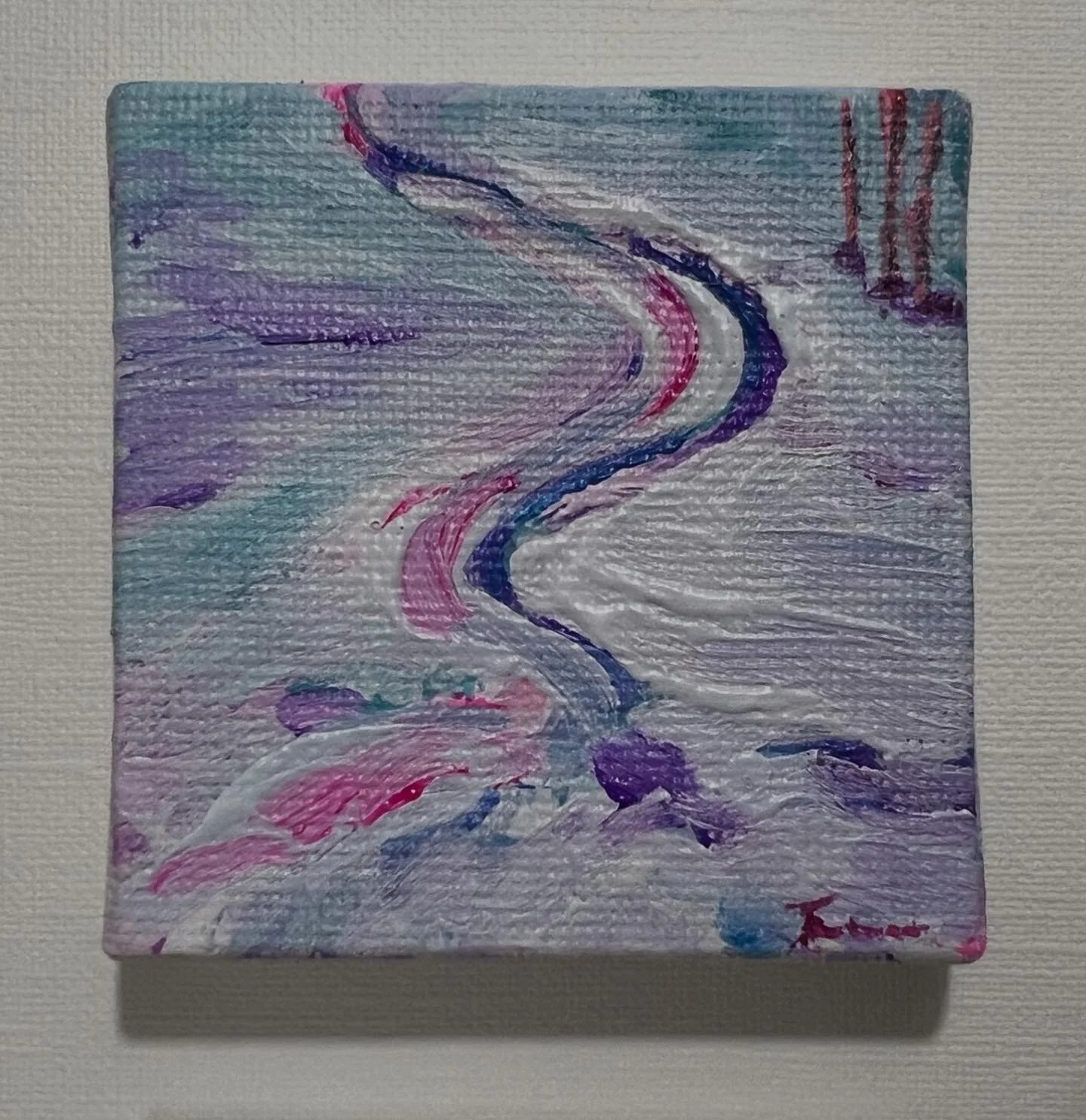 Small abstract painting of a winding river in various shades of blue, purple, pink, and white, on a textured canvas.