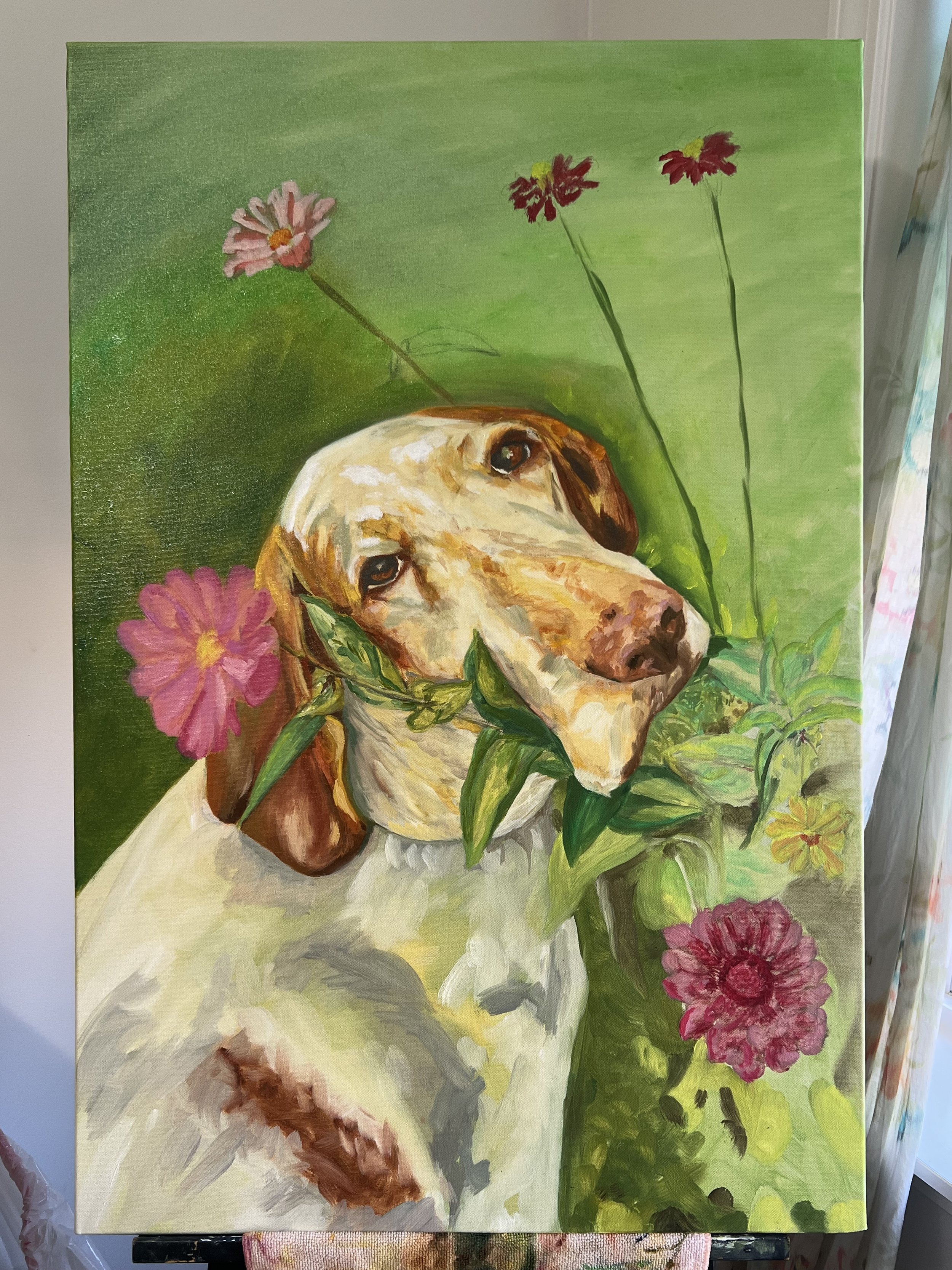 A painting of a dog with a garden of colorful flowers around it, featuring green background and various pink, red, and yellow flowers.