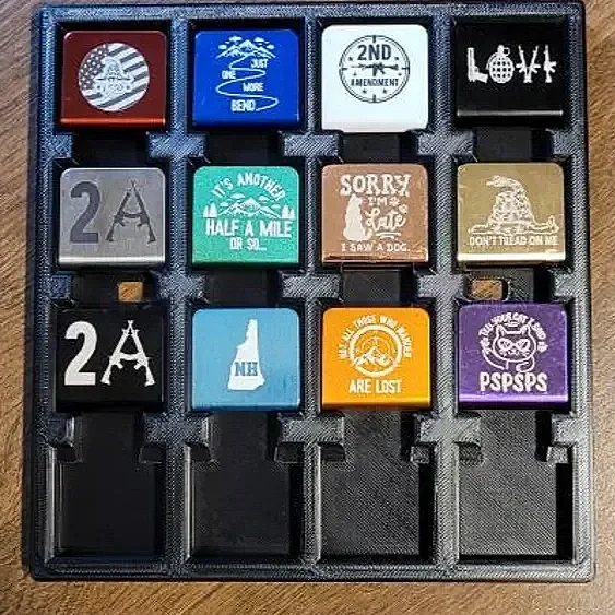 Variety of colorful rubber stamps with various designs and texts, arranged in a plastic tray.