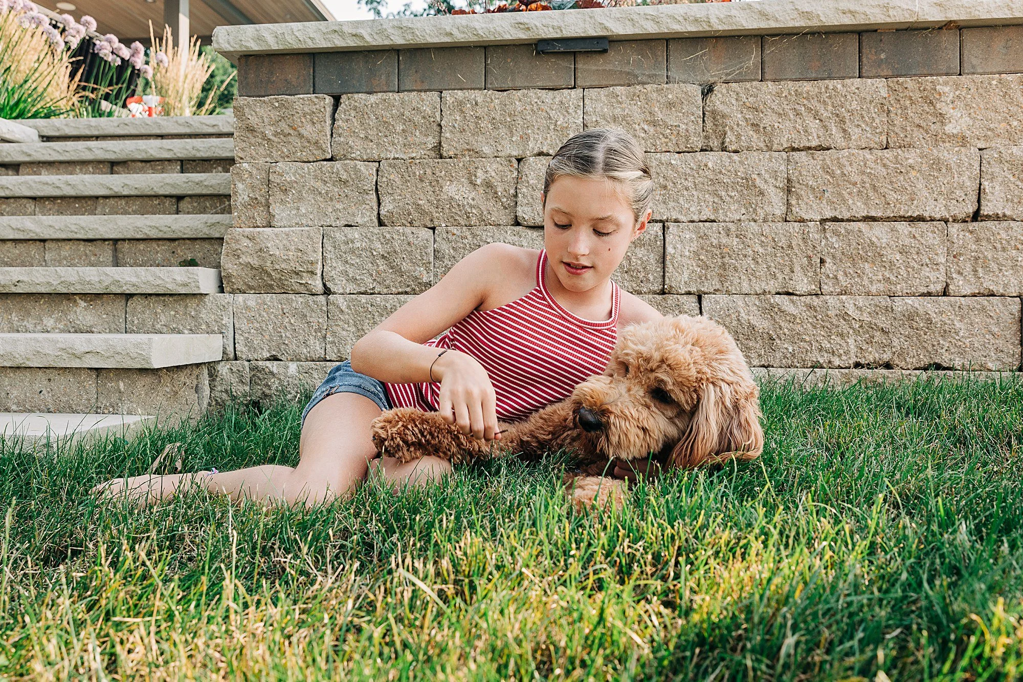 girl in the grass with dog