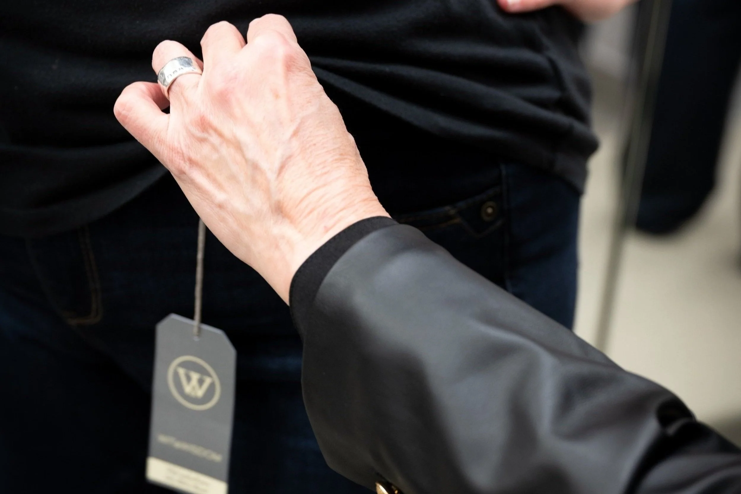 Professional stylist checking the fit of an article of clothing.