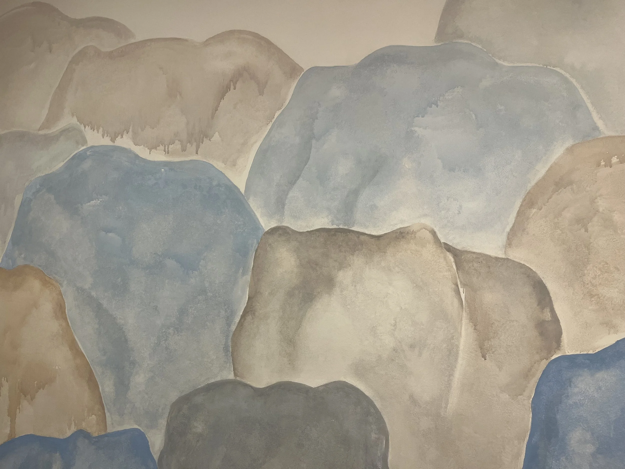 Patricia Machin Portfolio Designer and Art Director Abstract painting of large, rounded rocks in earthy tones of beige, brown, gray, and blue.