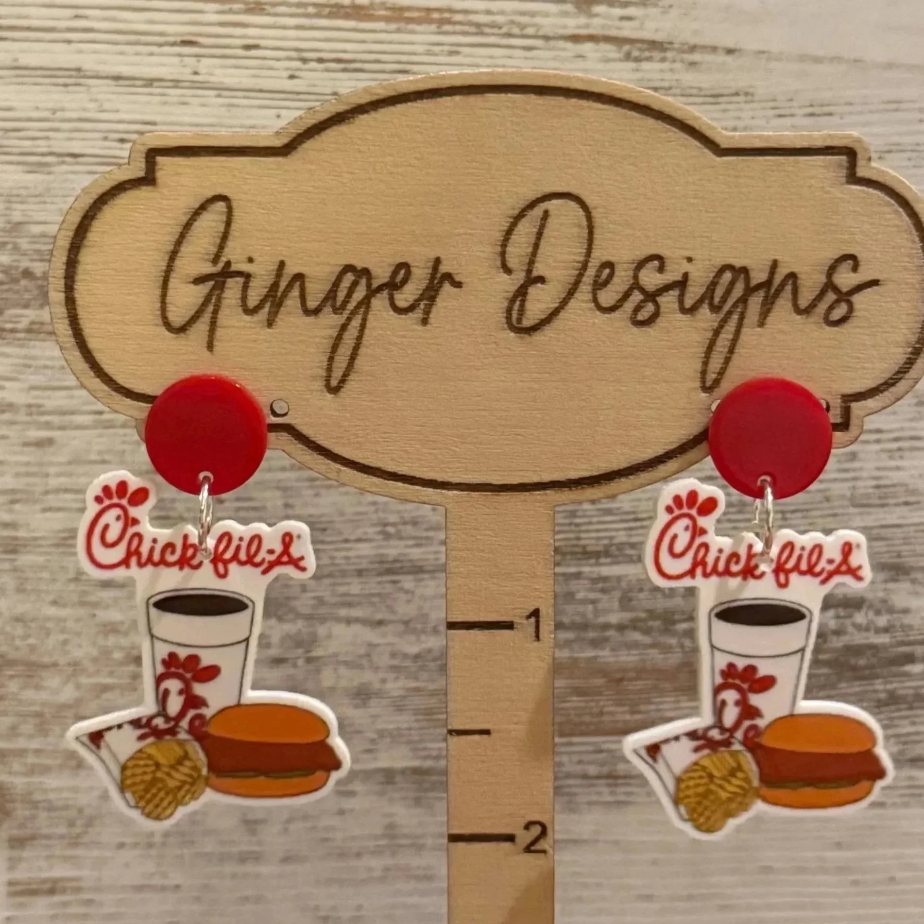 Chick-fil-A themed earrings featuring a chicken, a cup with a straw, a chicken sandwich, and waffle fries.