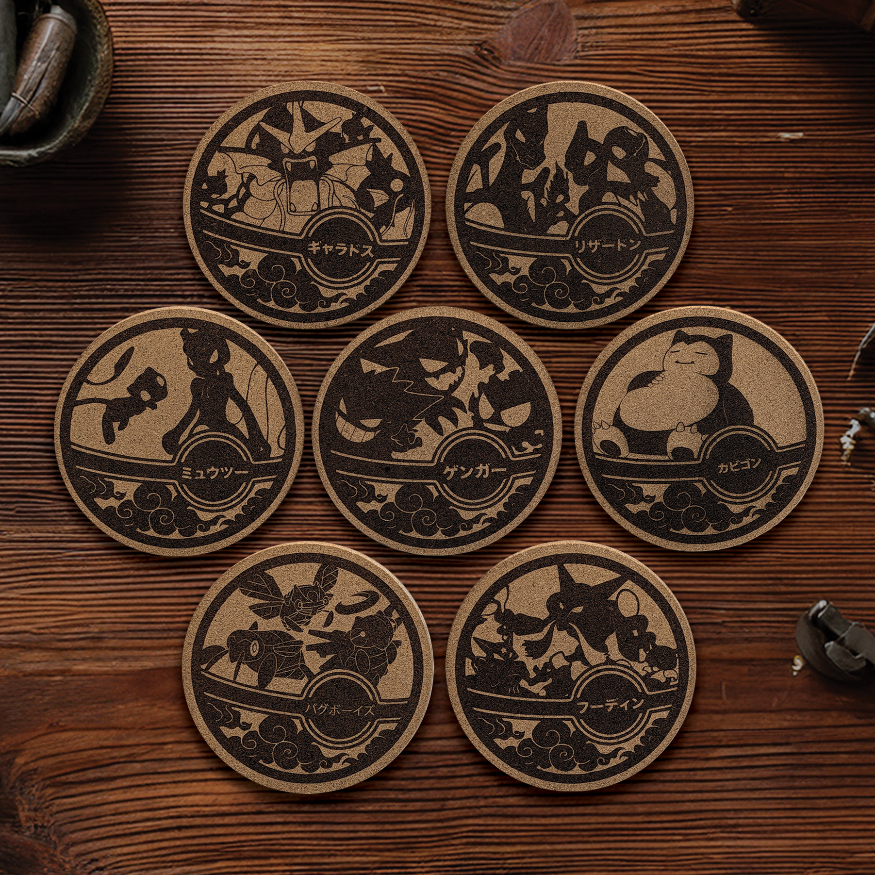 Six Pokémon-themed tokens with silhouettes of Pokémon and Japanese labels on a wooden surface.
