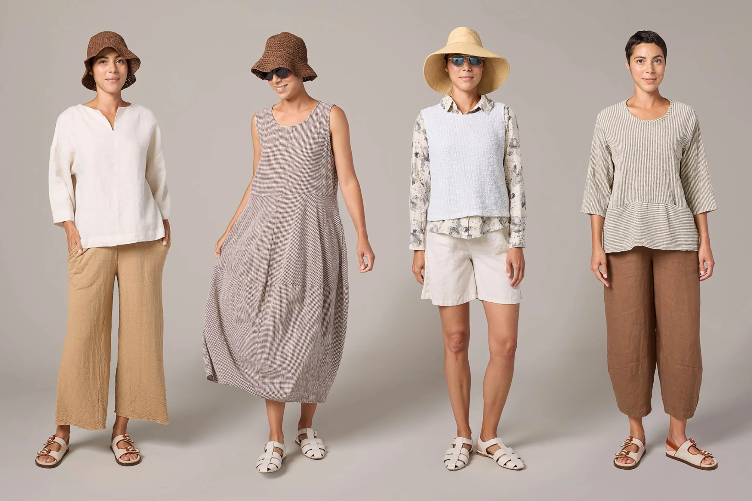 Four women modeling casual summer outfits, including wide-leg pants, sundresses, and layered tops, accessorized with hats, sunglasses, and sandals, standing against a neutral background.