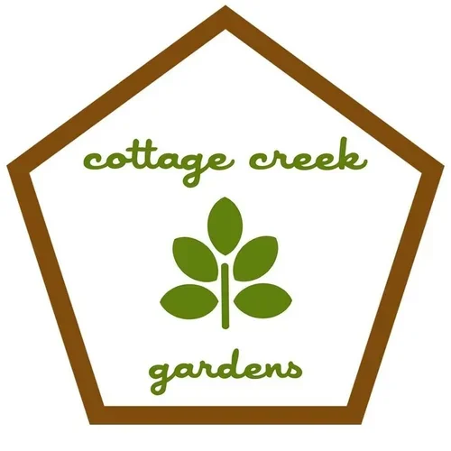 Cottage Creek Gardens logo with a brown-outlined pentagon shape, green leaf graphic, and green text