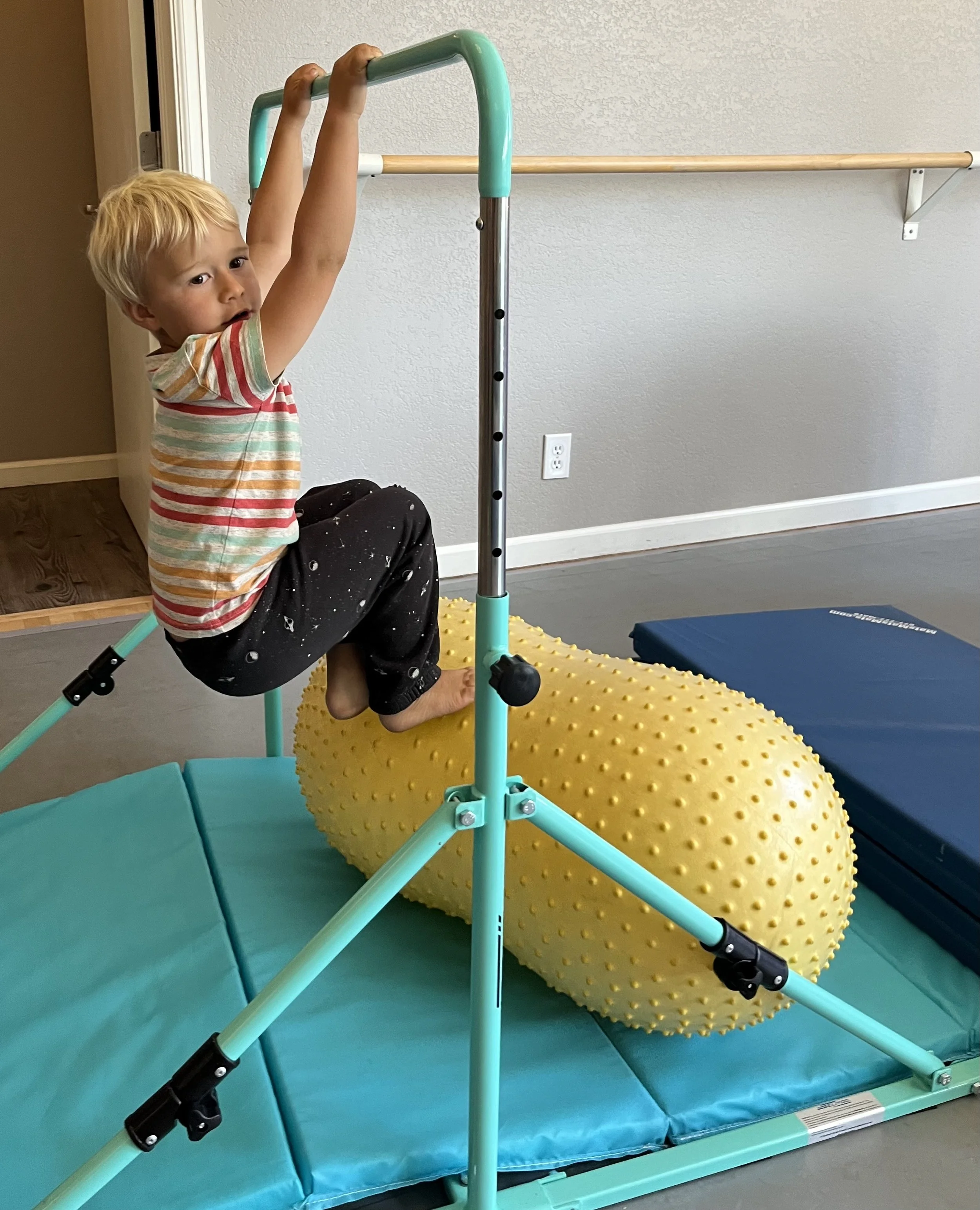 A young boy doing gymnastics in Steamboat Springs Colorado. toddler open gym play area