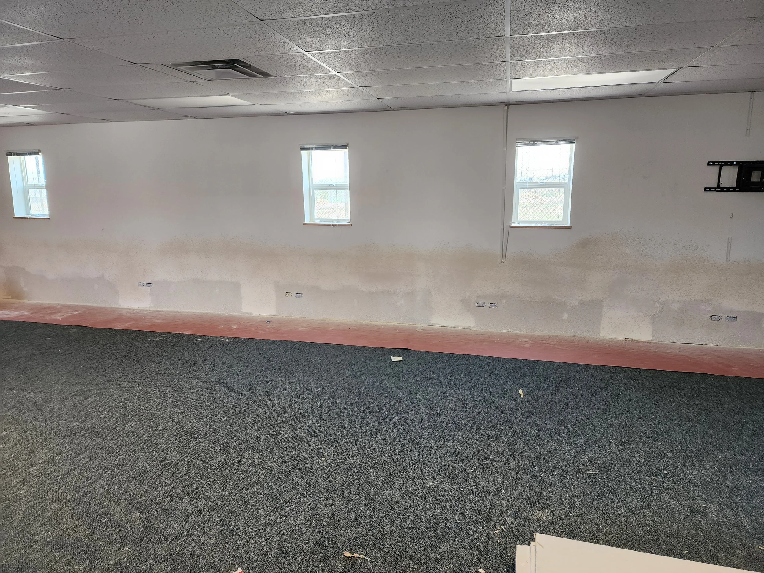 Commercial interior renovation in progress including texturing by Evolution Drywall & Restoration