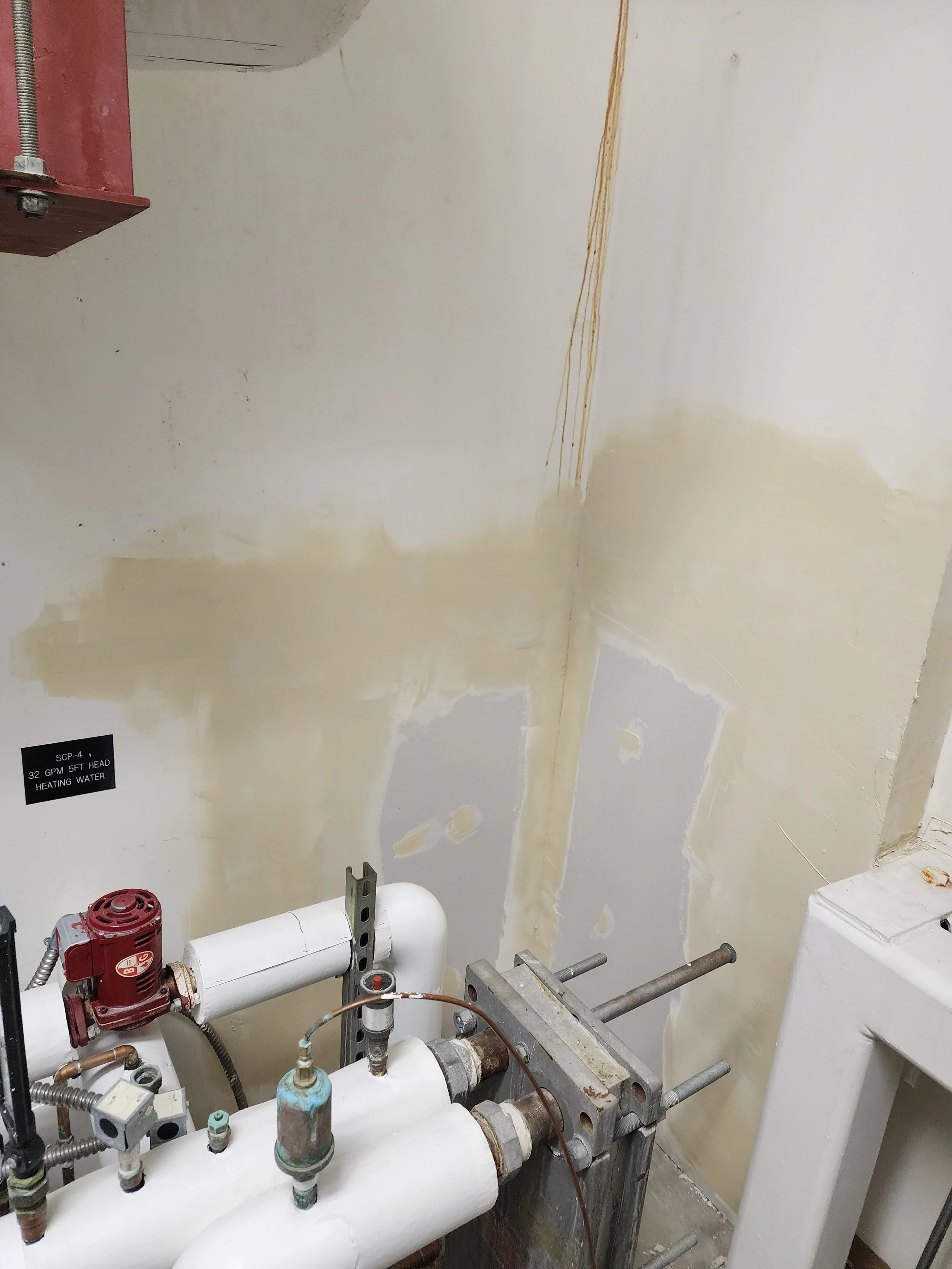 Drywall repair and commercial restoration in mechanical room by Evolution Drywall & Restoration