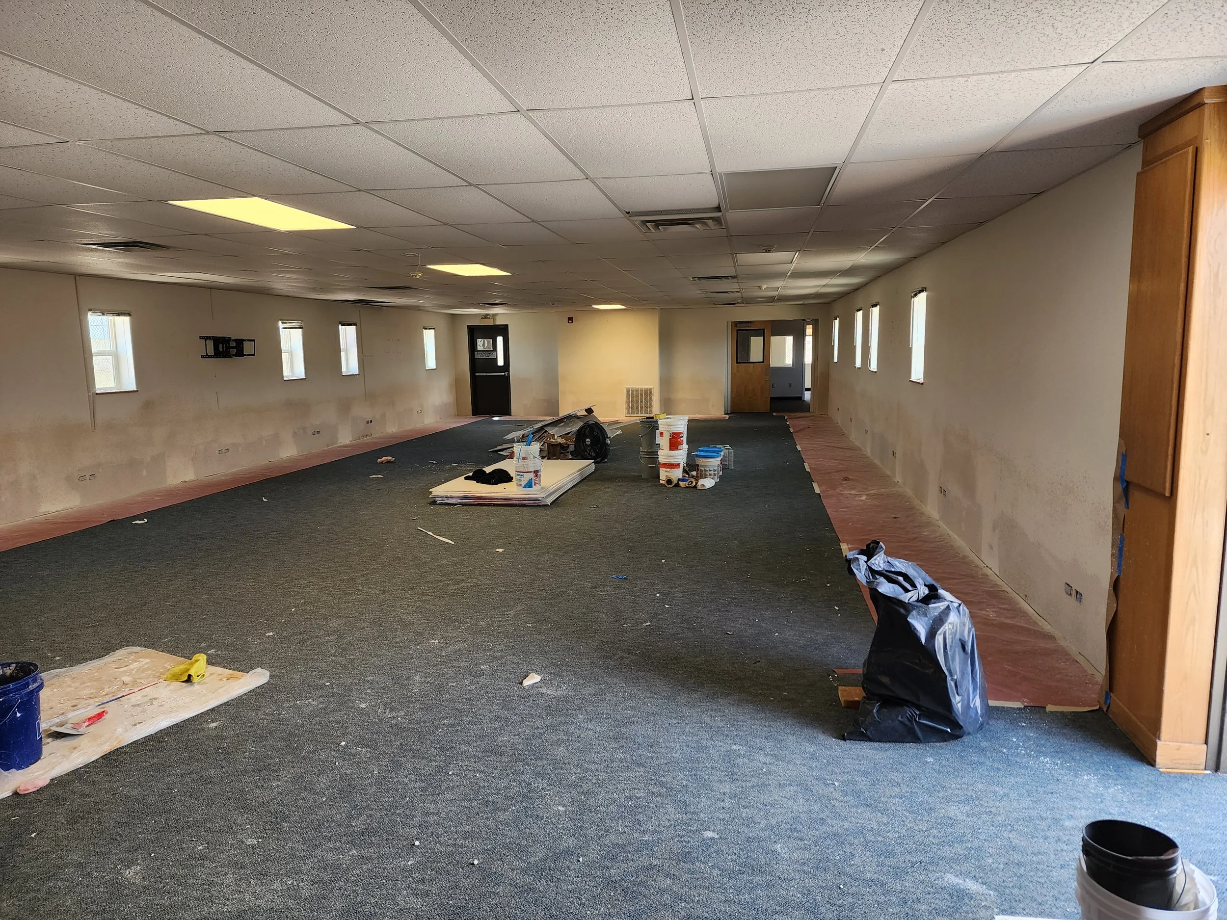 Commercial interior renovation in progress including drywall preparation by Evolution Drywall & Restoration