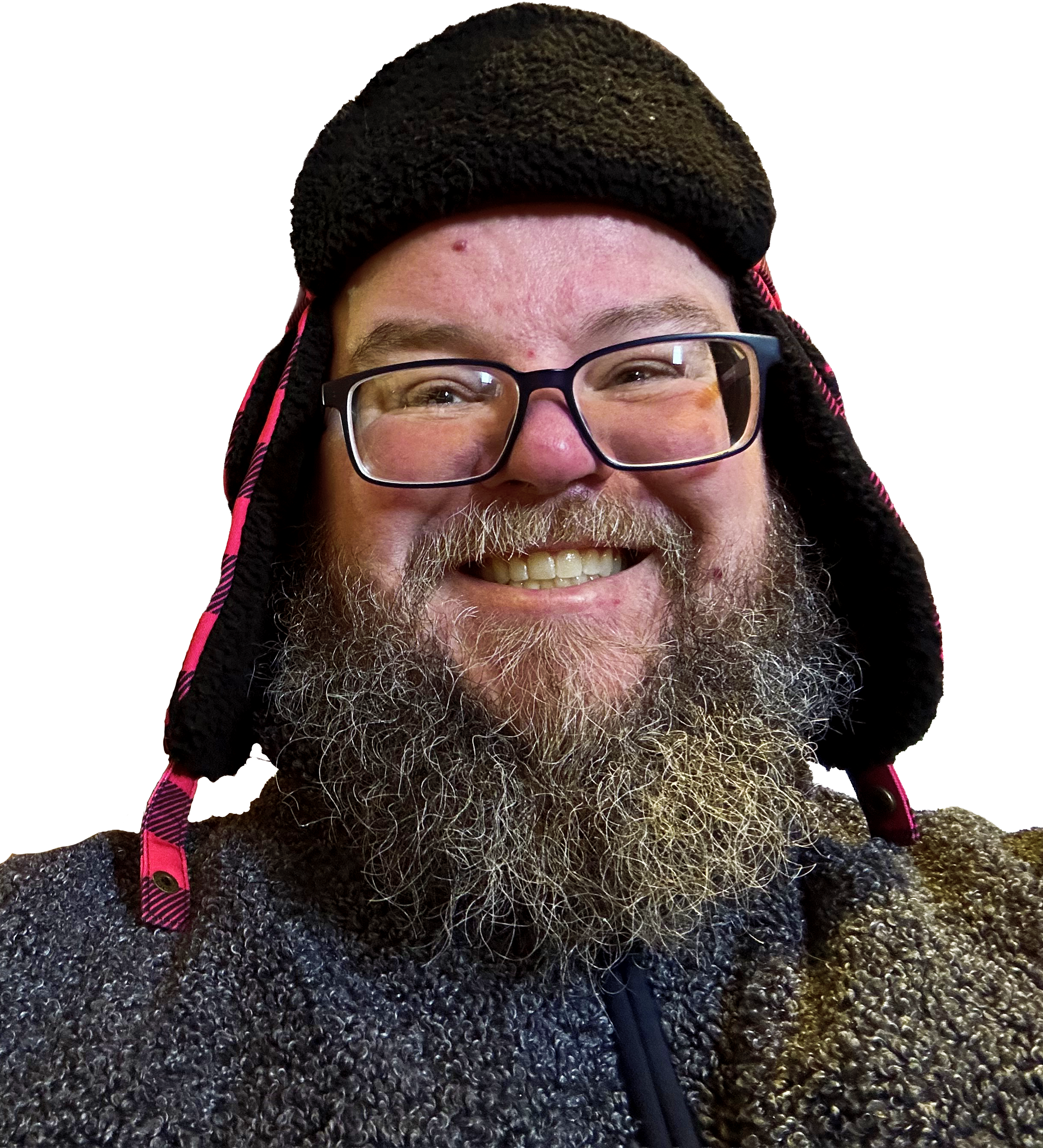 A bearded man with glasses smiling and wearing a trapper hat.