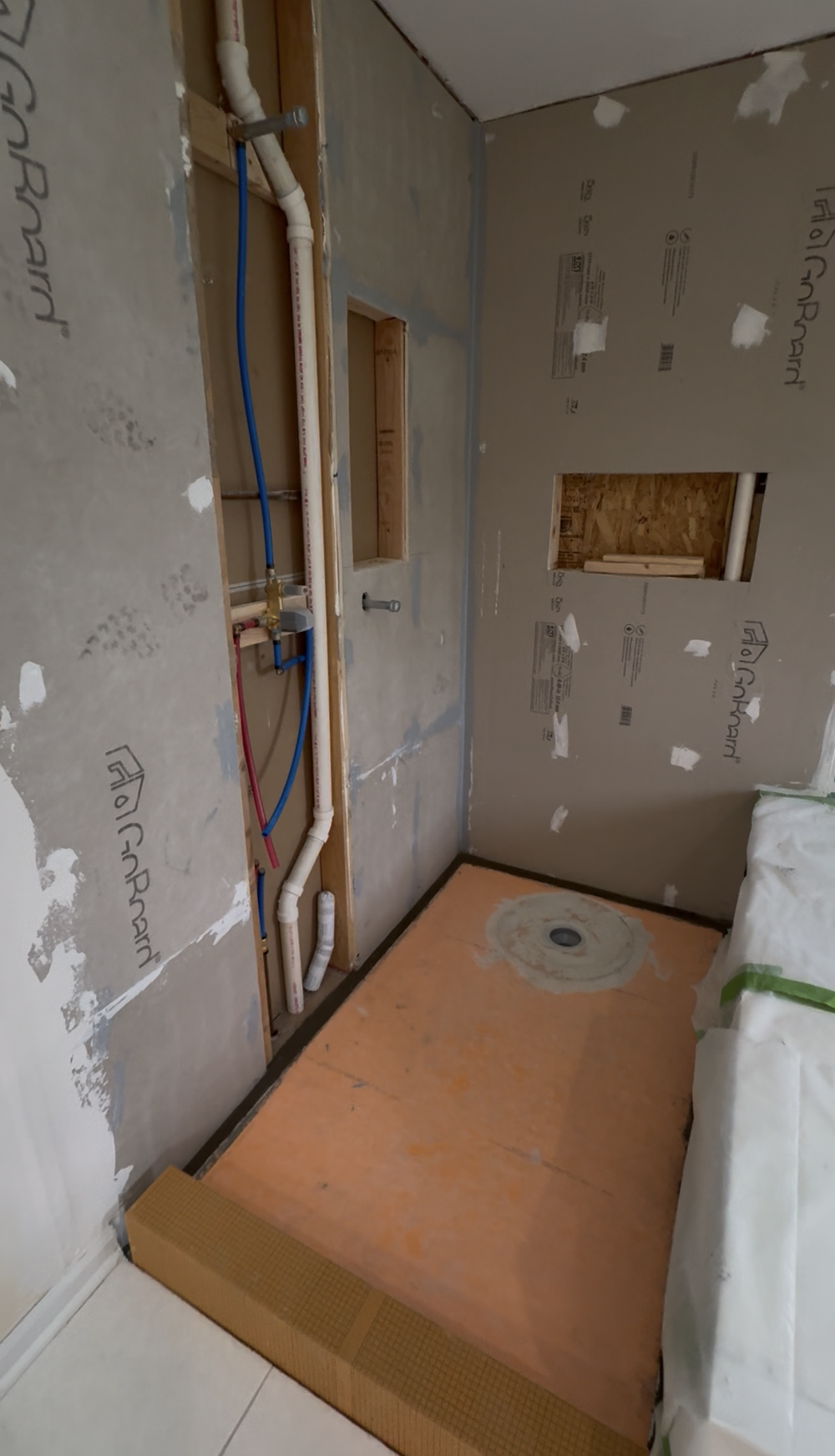 Shower Base Preparation — The shower base and curb before tile installation.
