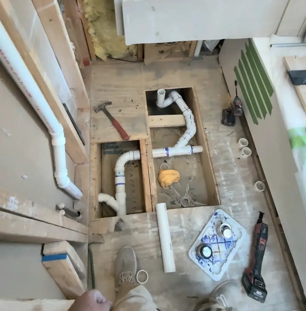 Relocated Drain Plumbing — The drain plumbing arranged for the new shower layout.