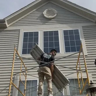 Window-trim work underway from exterior scaffolding