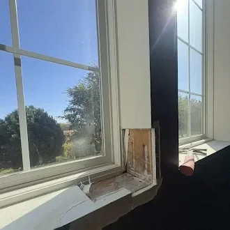 Window perimeter masked during exterior trim work