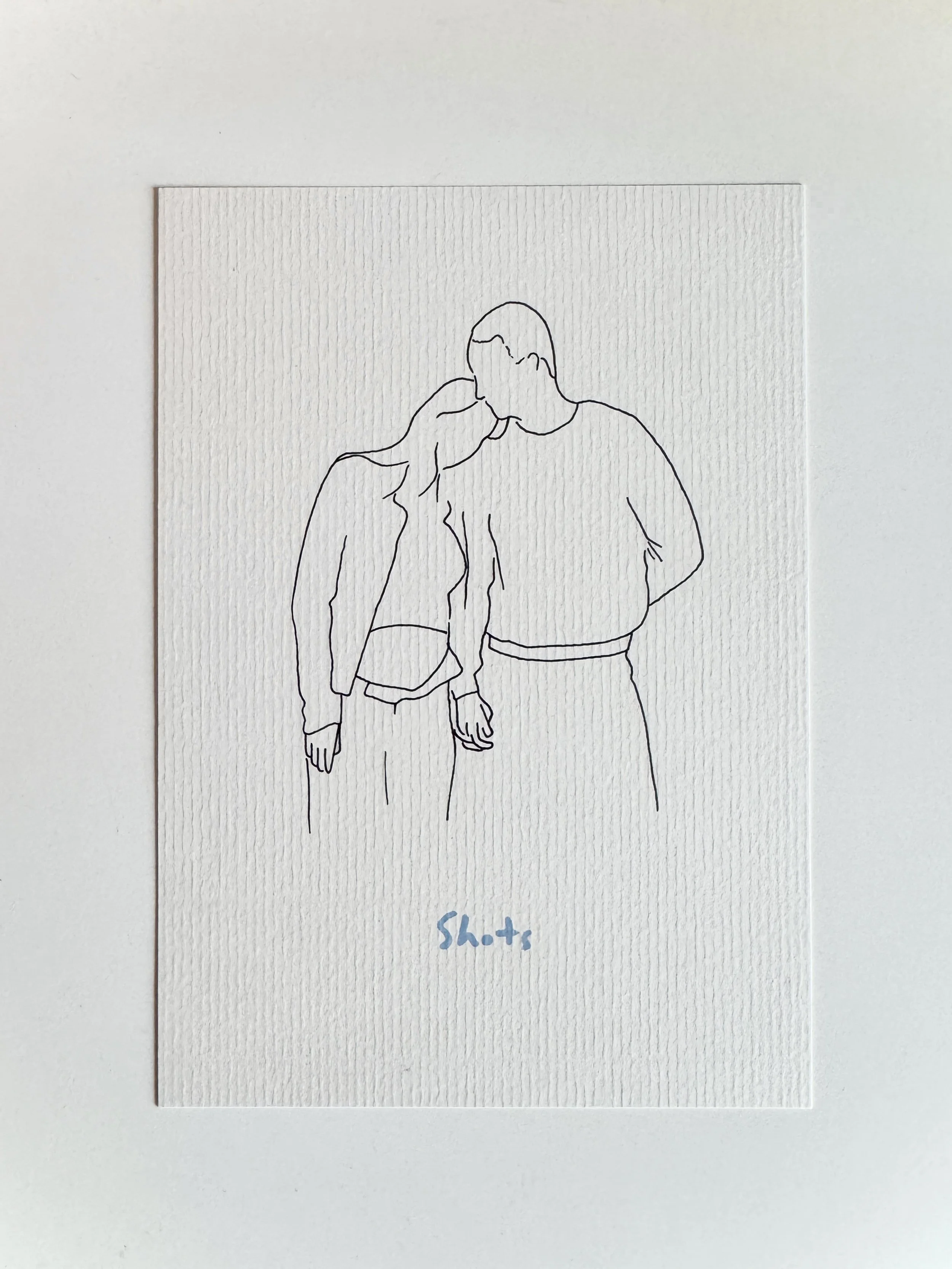 Lijntekening van een kussend stel met het woord ‘Shots’ eronder.