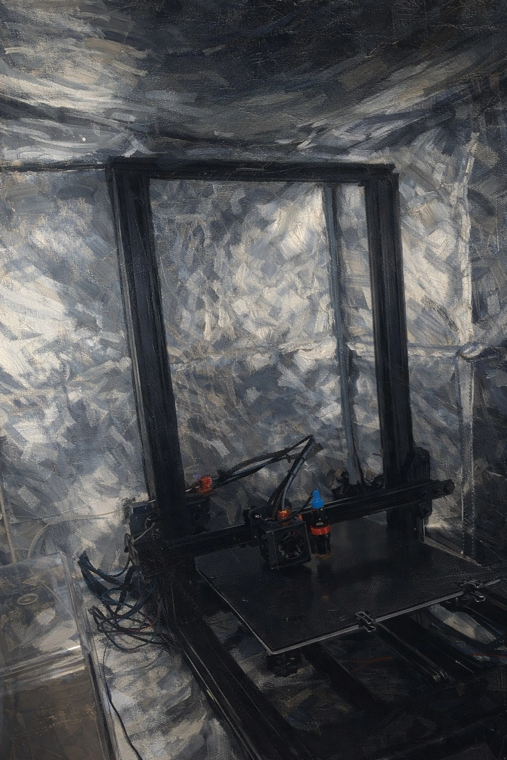 A black 3D printer inside a reflective, metallic enclosure with a partially constructed object on the print bed.
