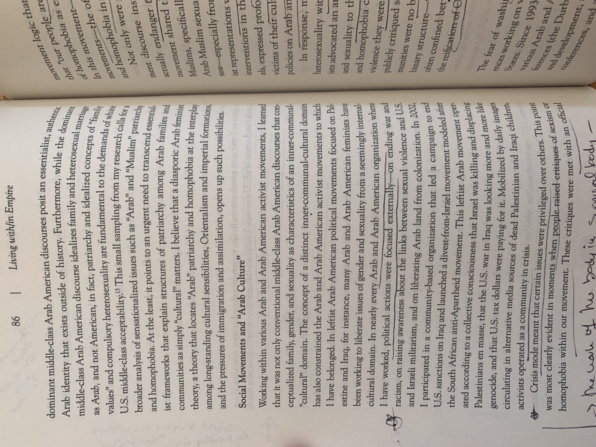 A close-up of a page from a book with small, densely packed text, some handwritten notes or annotations in the margin. The page is slightly curved at the edges and appears to be old.
