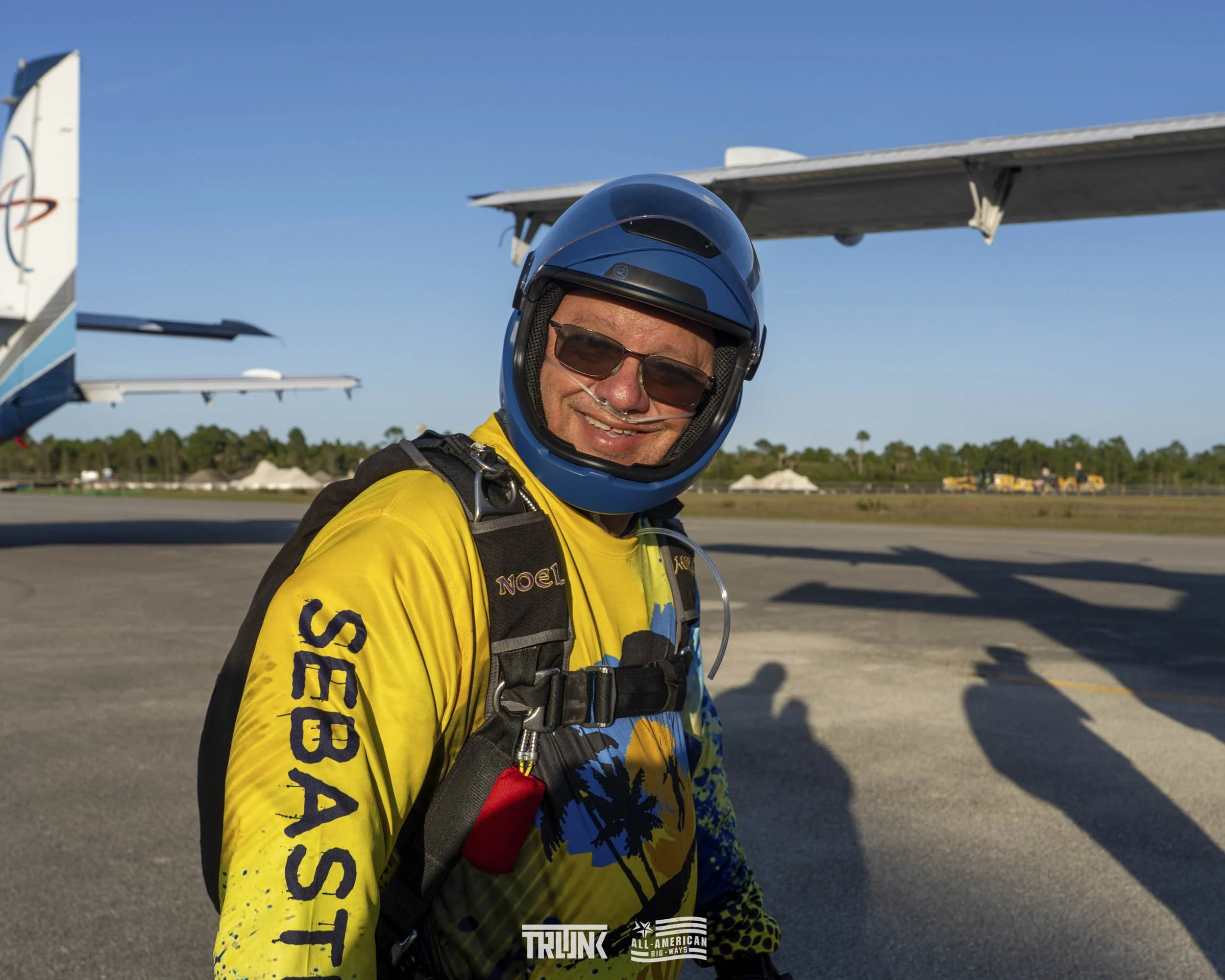 A man in a yellow skydiving suit with 