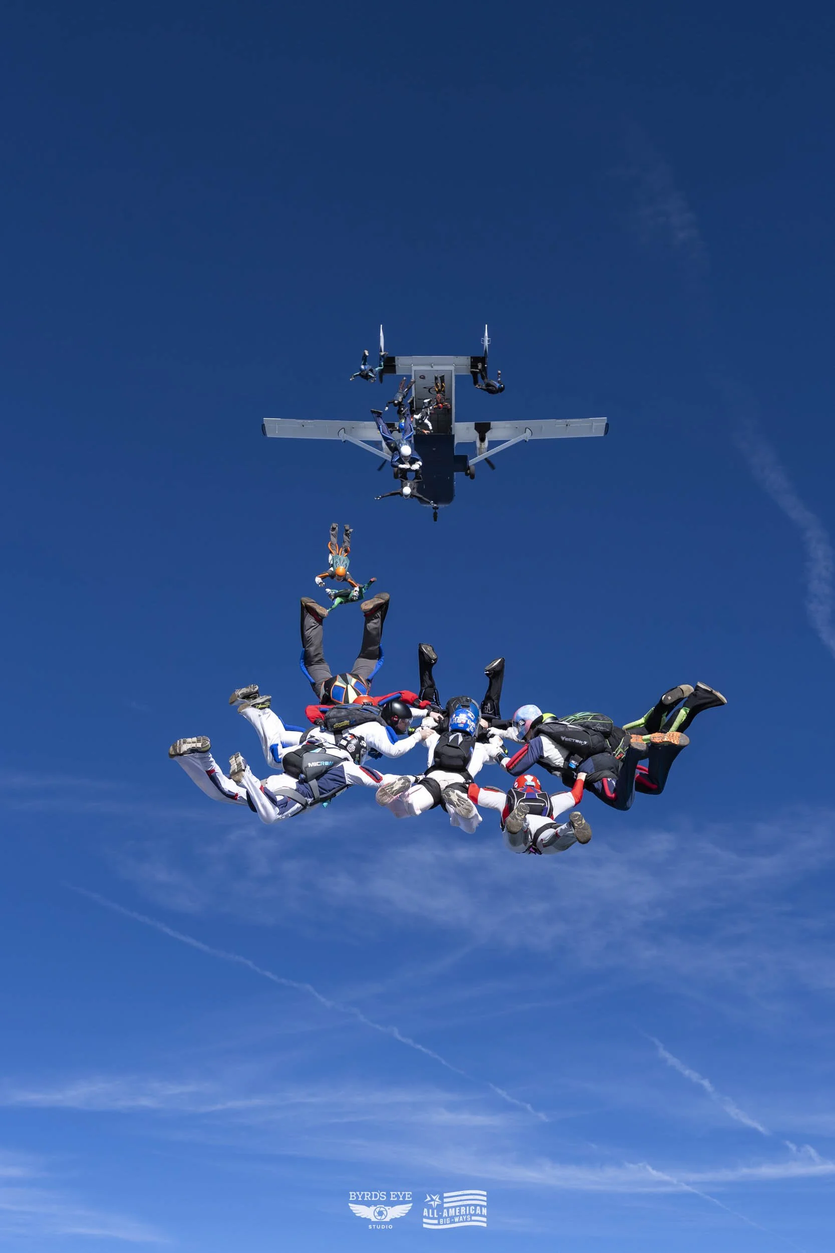 Skydivers free-falling from a plane against a blue sky