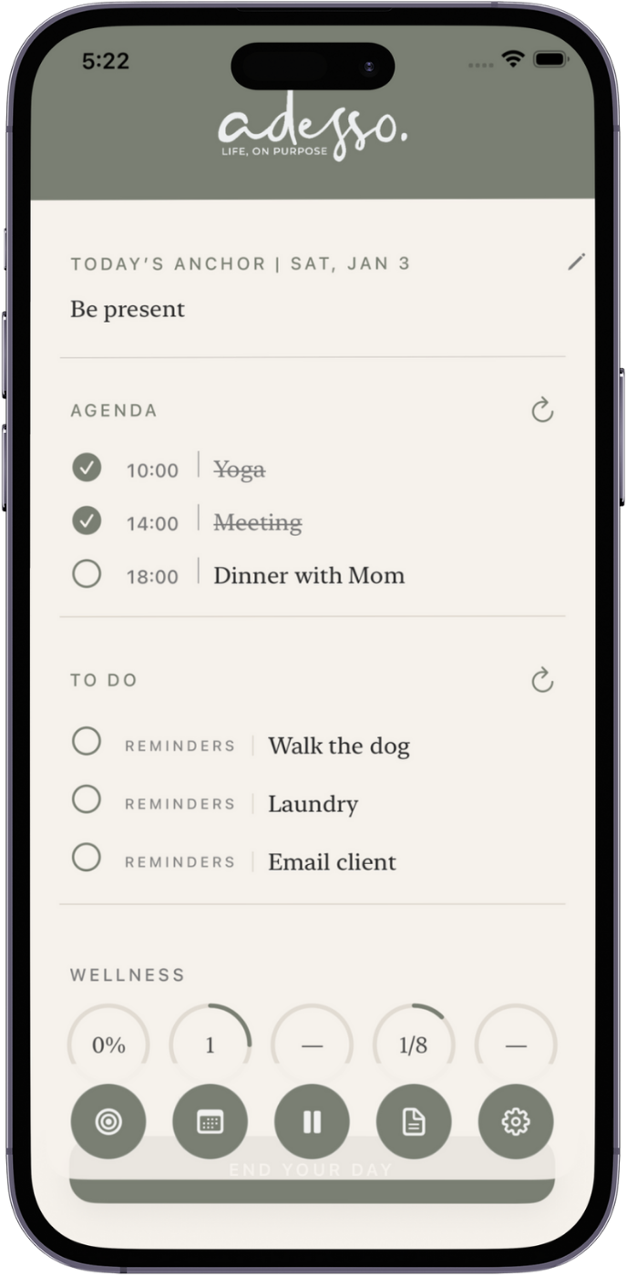 A smartphone screen displaying a digital planner or daily organizer app with the title 'adosso' and the tagline 'Life, On Purpose.' The planner shows today's date as Saturday, January 3, with a focus on being present. The agenda includes a yoga session at 10 a.m., a meeting at 2 p.m., and dinner with mom at 6 p.m. The to-do list has reminders to walk the dog, do laundry, and email a client. Wellness progress is tracked with meters, and various icons at the bottom include targets, a keyboard, a pause button, a document, and settings. The phrase 'End your day' appears at the bottom.