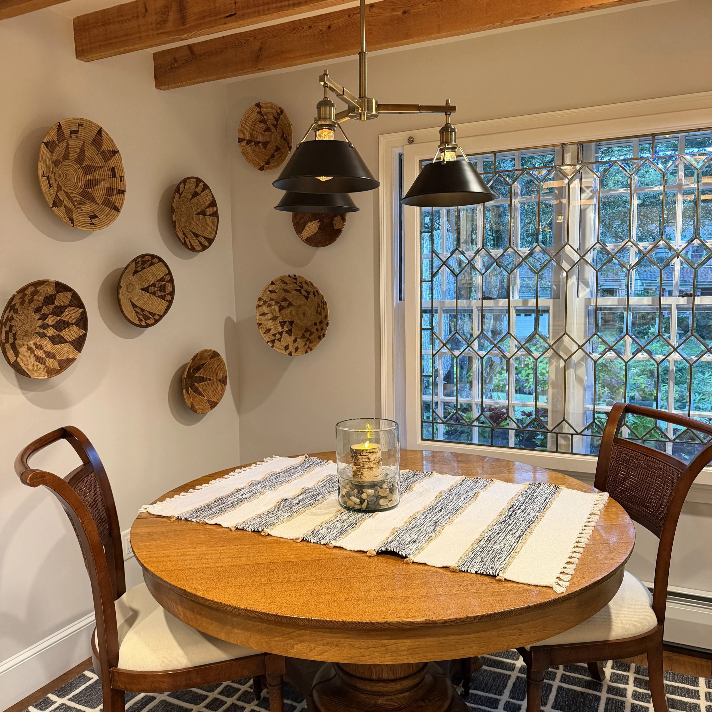 Leaded glass windows spotlit a bevy of African baskets
