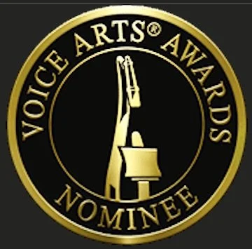 Voice Arts Awards Nominee badge with a gold border and black background, featuring a raised hand holding a trophy.