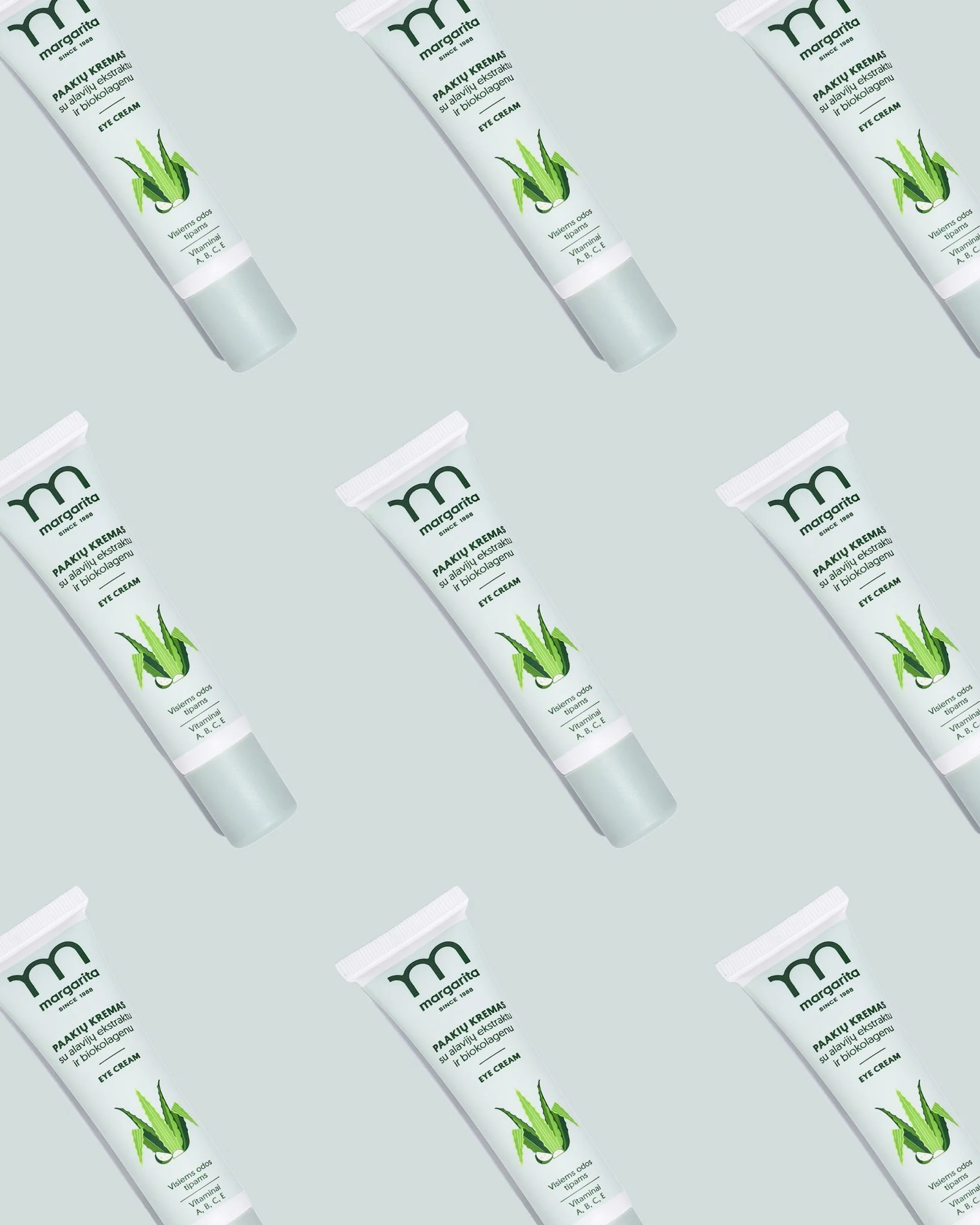 Pattern of multiple tubes of aloe vera eye cream lying diagonally, with the label facing forward, on a light background.