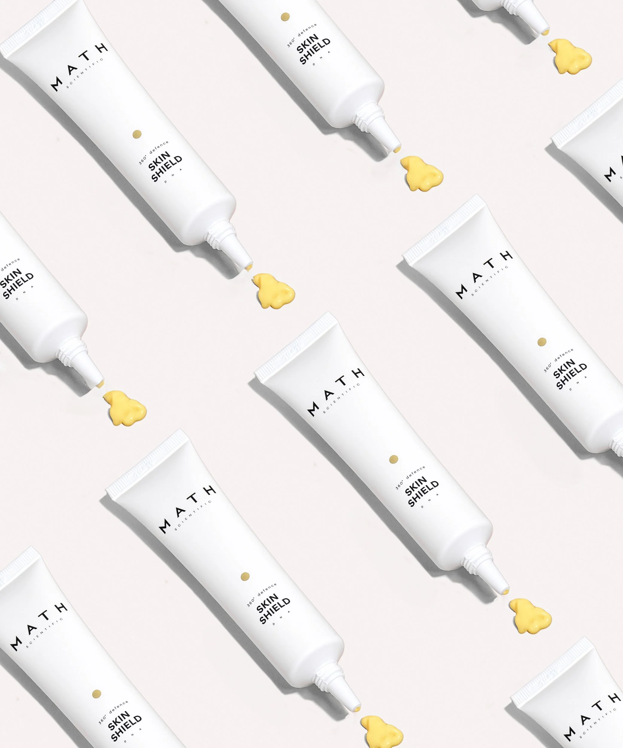 Product photography for Lithuanian skincare brand Math Scientific, featuring Skin Shield tubes styled in a minimalist white composition.