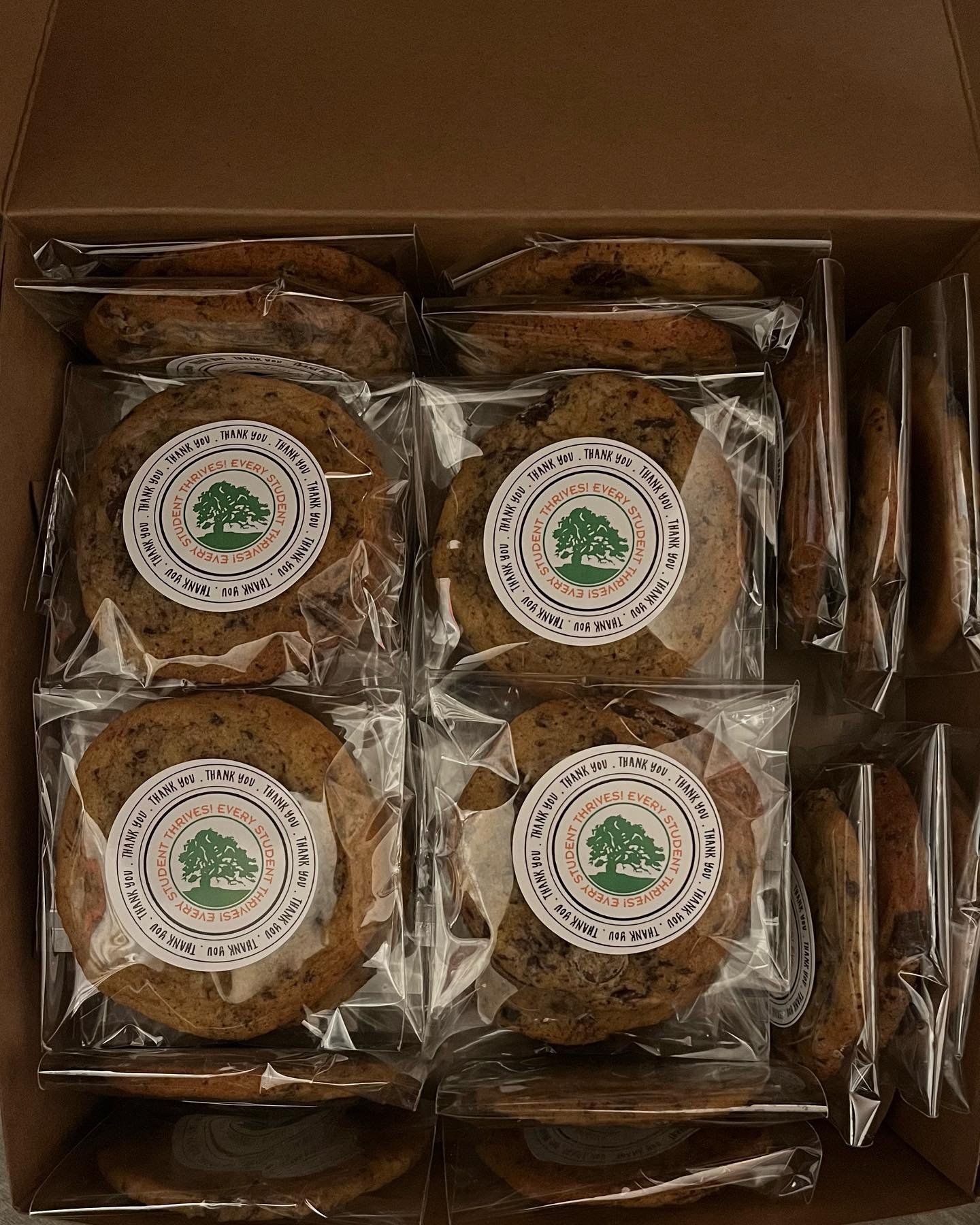 A box of individually wrapped chocolate chip cookies with a green and white logo on each.