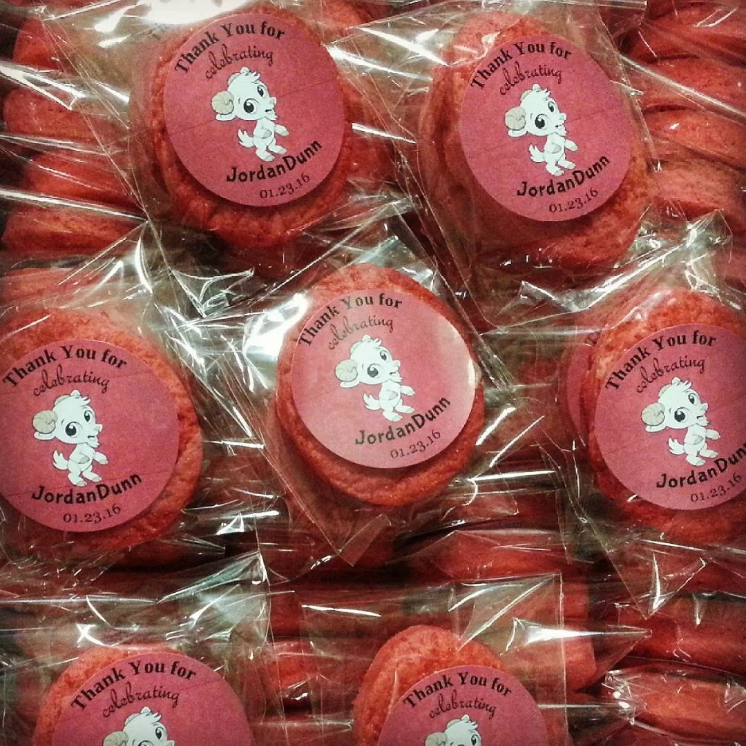 Pink circular cookies with a thank you sticker, featuring a cartoon dog, celebrating JordanDunn's event on January 23, 2016, each wrapped in clear plastic.