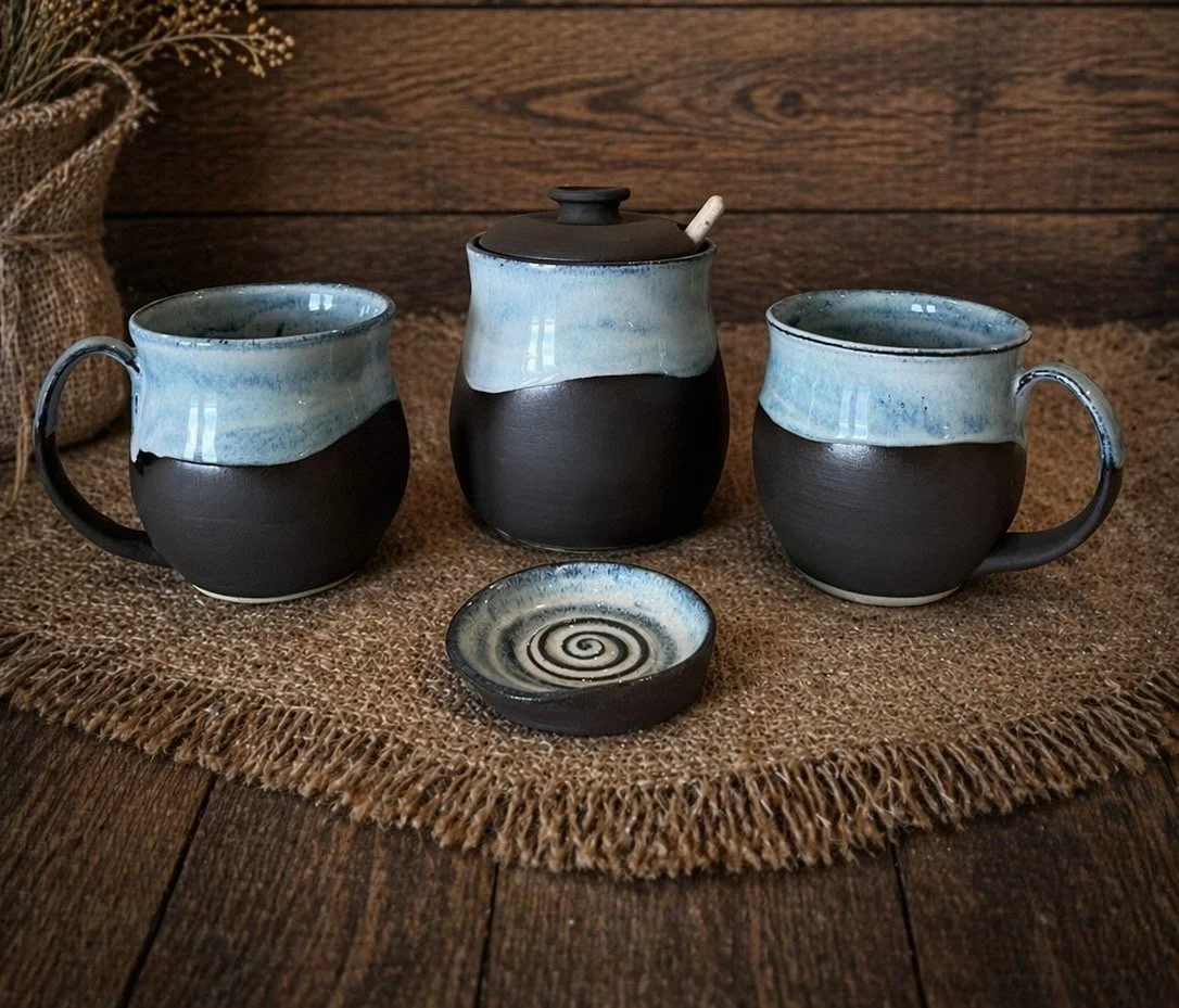 Set of handmade ceramic mugs and a small dish 
