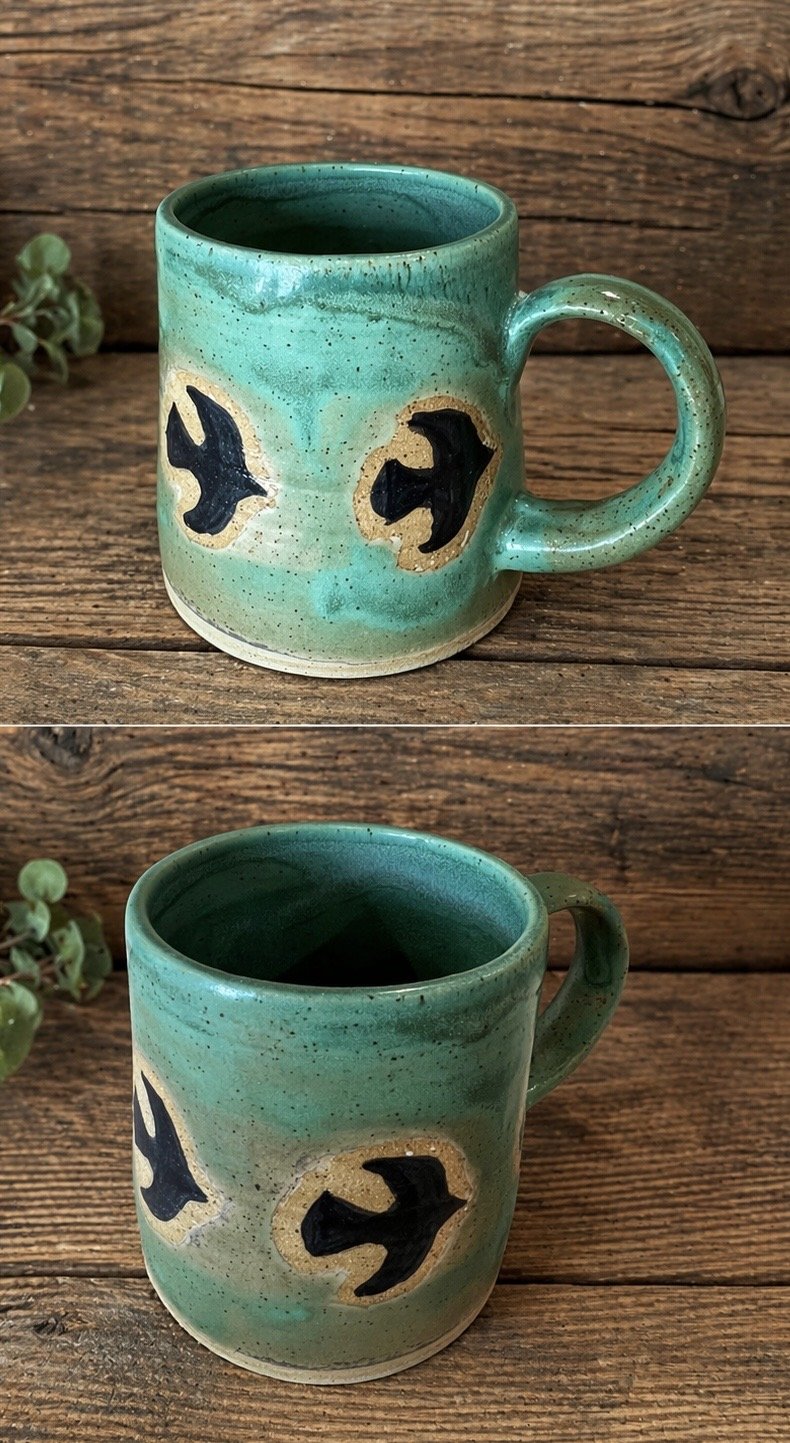 A ceramic mug with a turquoise glaze finish, decorated with silhouettes of birds in flight 