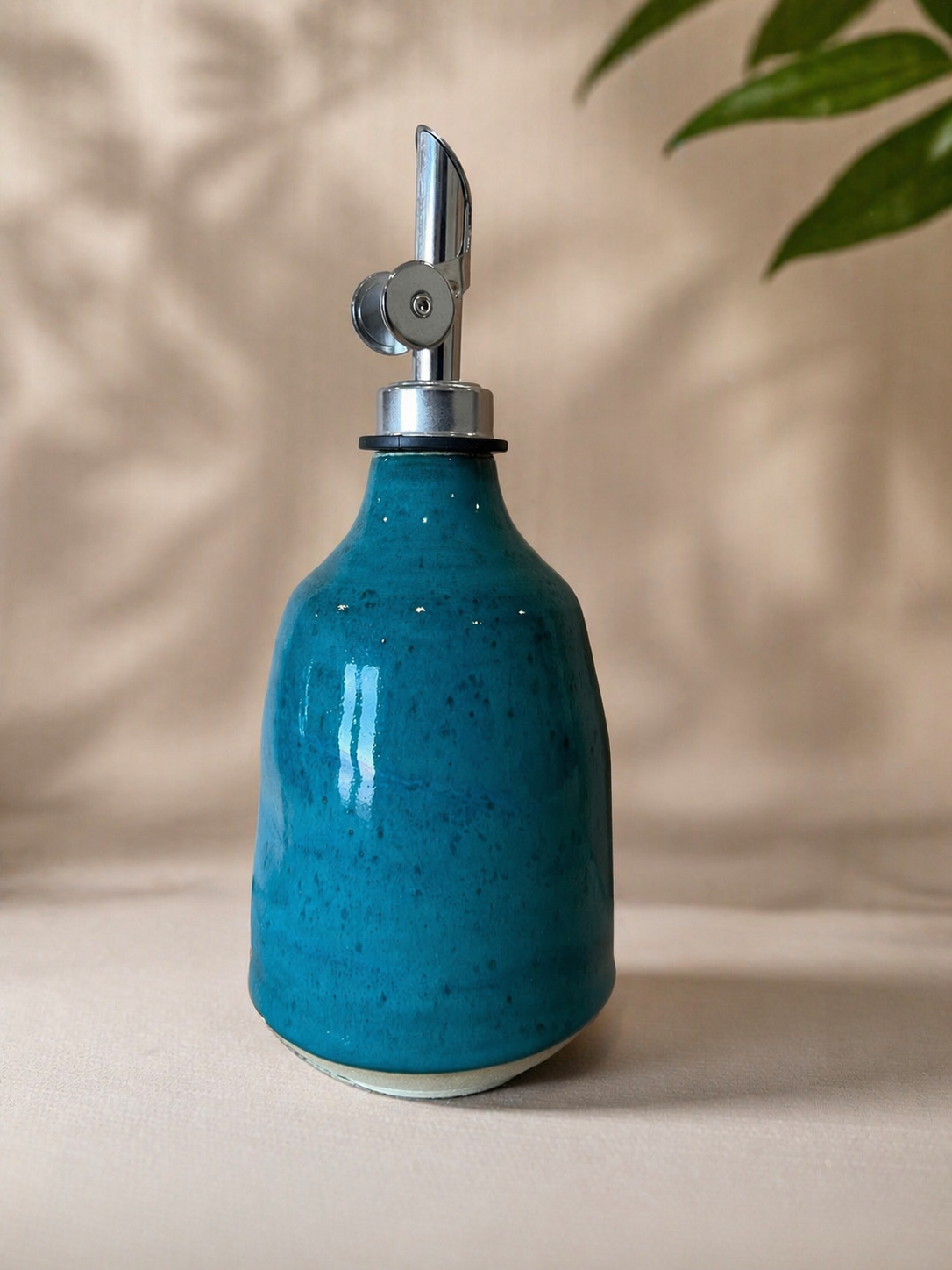 A blue ceramic oil cruet