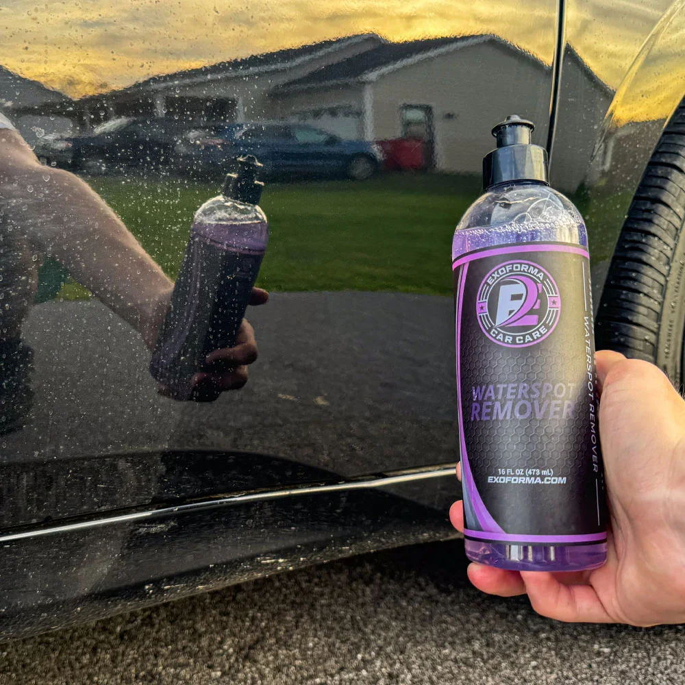 Water spot removal service on black vehicle paint, eliminating mineral deposits and restoring a clean, spot-free finish.