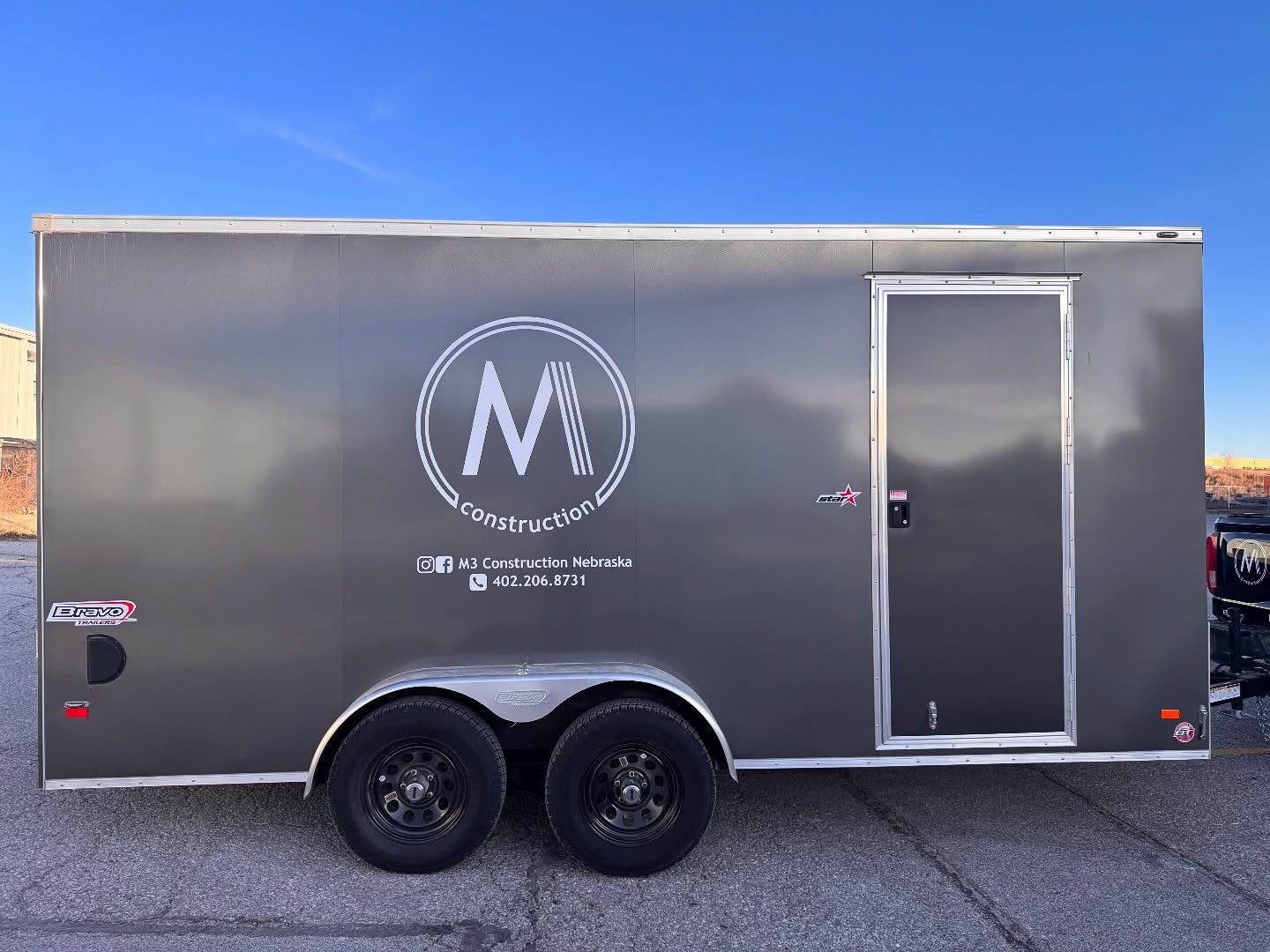 The M3 Construction trailer. Can be found parked in and around Lincoln Nebraska on their current job site. Their logo, social media, and number are on the side for visibility.