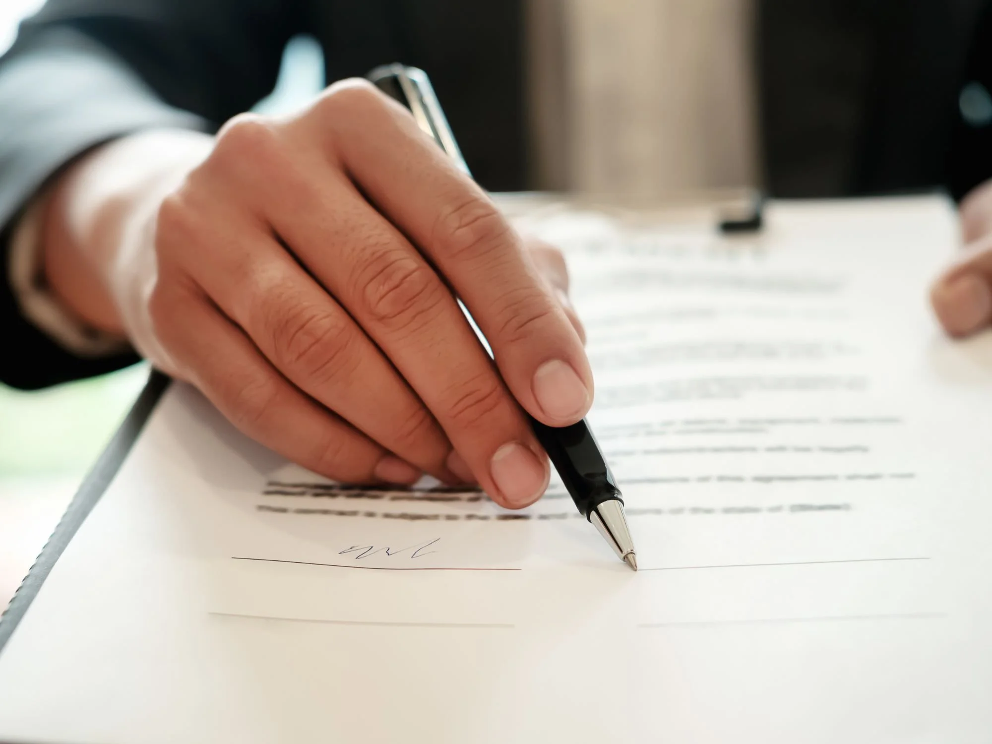 Man's hand pointing where to sign on a divorce document  - ira divorce