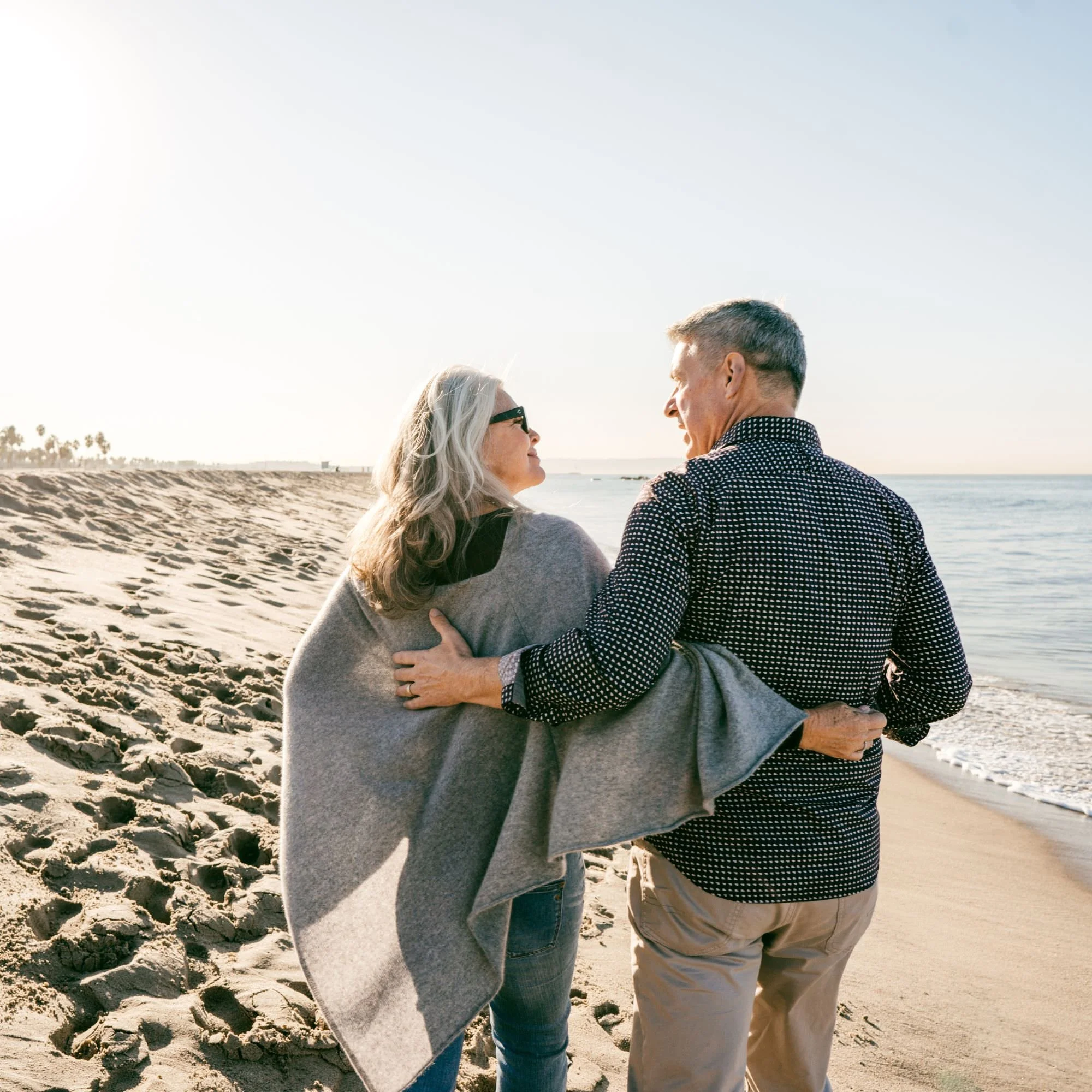 couple walking on the beach - Retirement Income Planning