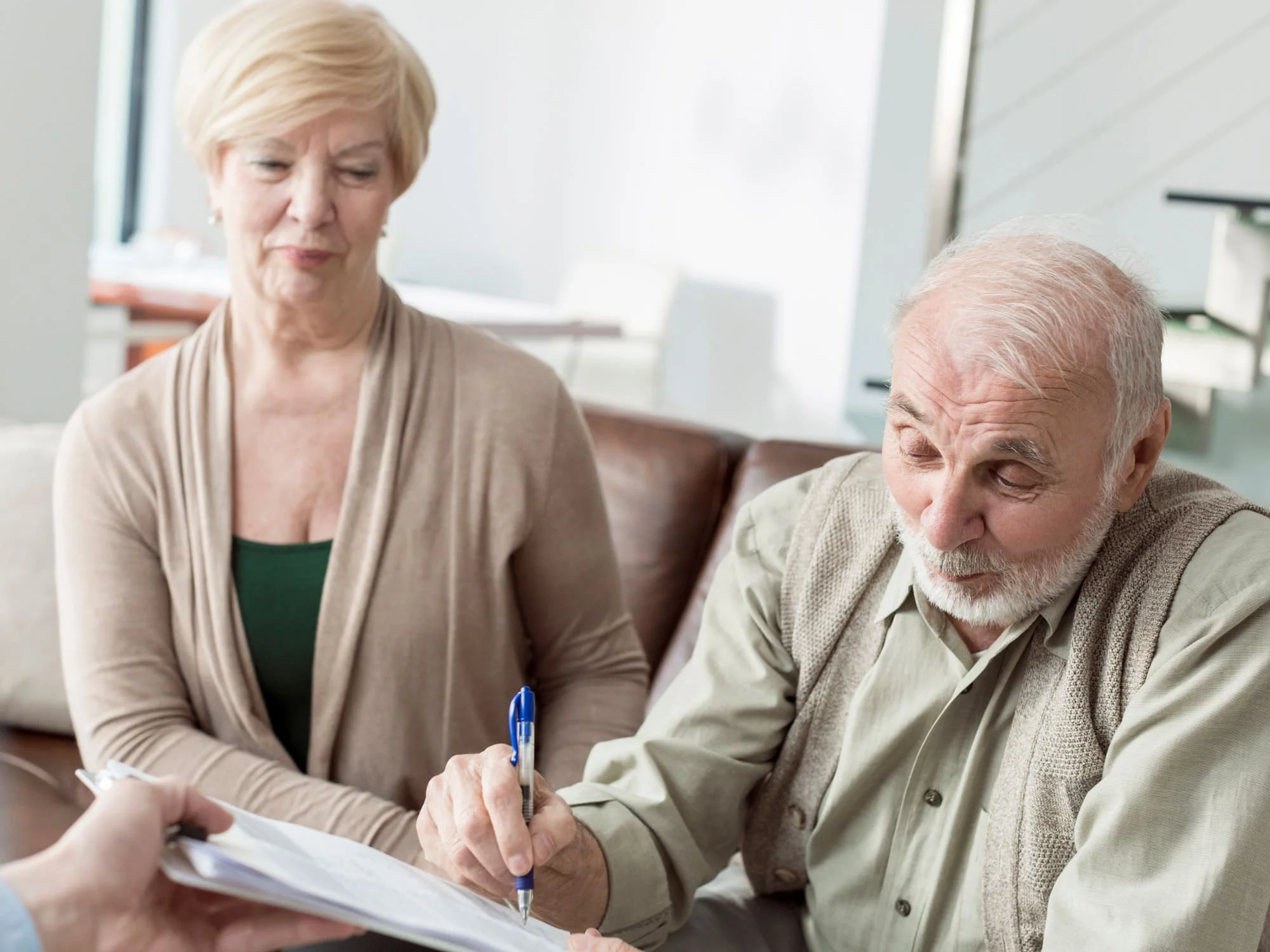 older couple signing paperwork - QRDO divorce