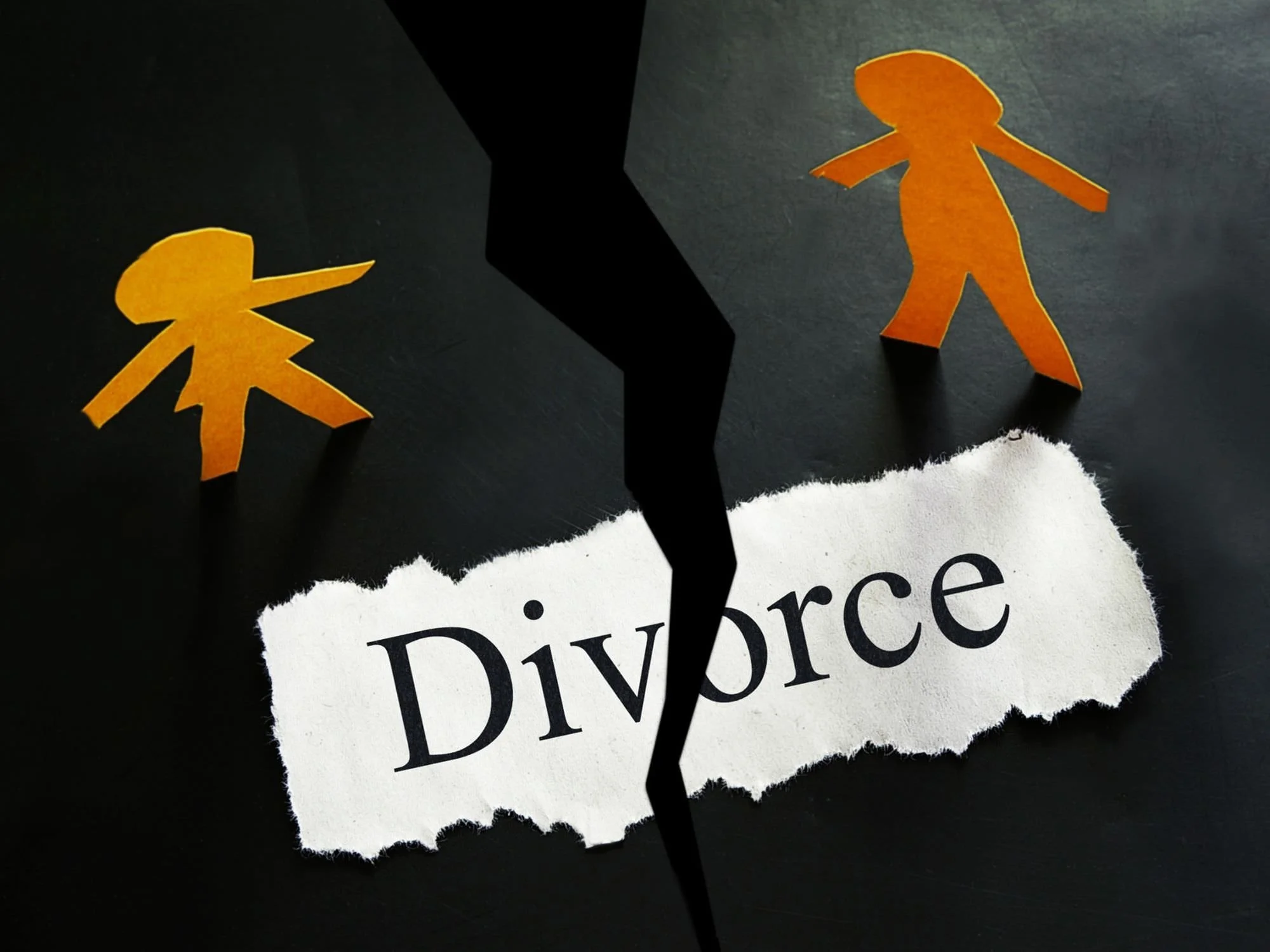 Cut out figures of a man and a woman with the word "divorce", all with cut through in half.