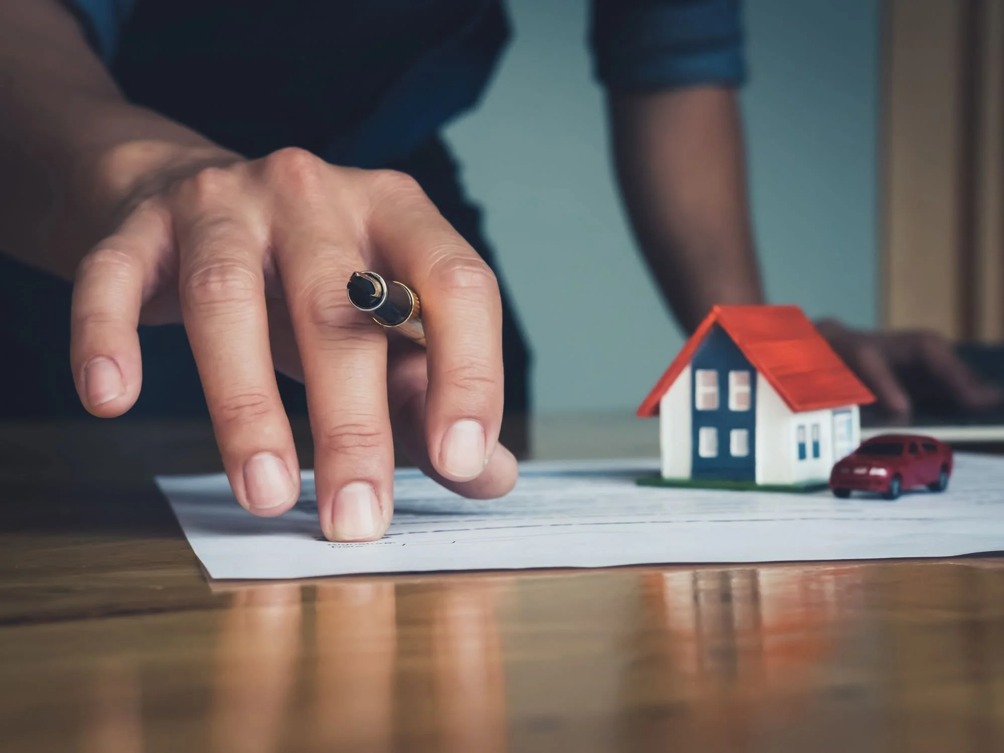 financial paperwork, toy house and car