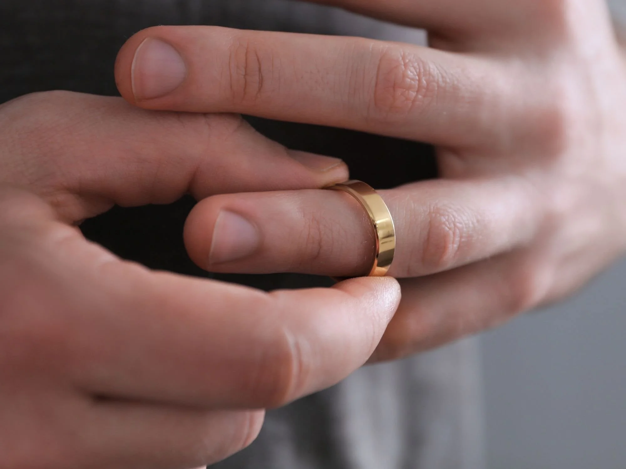 man fiddling with wedding ring