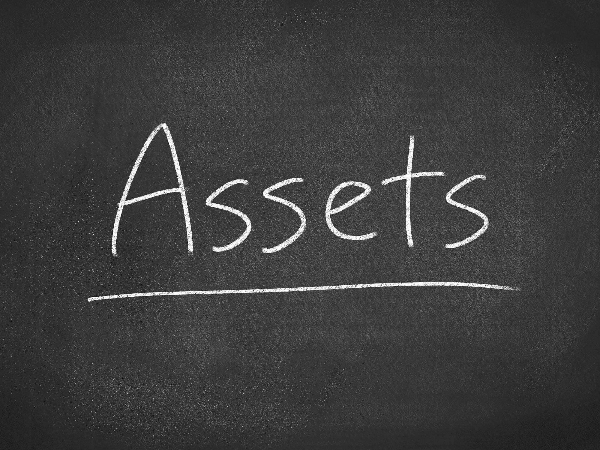 the word assets on a chalkboard