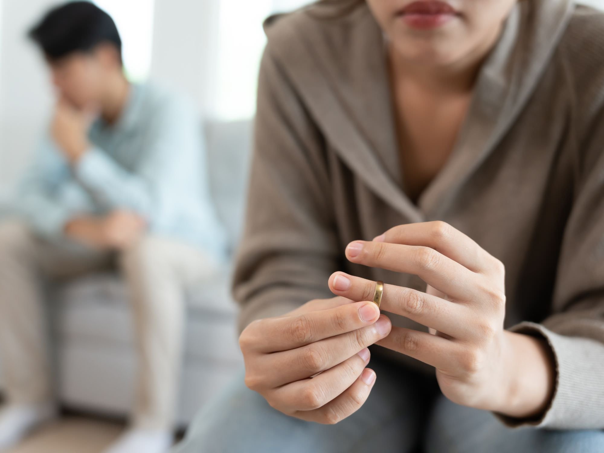 woman playing with ring with back to man