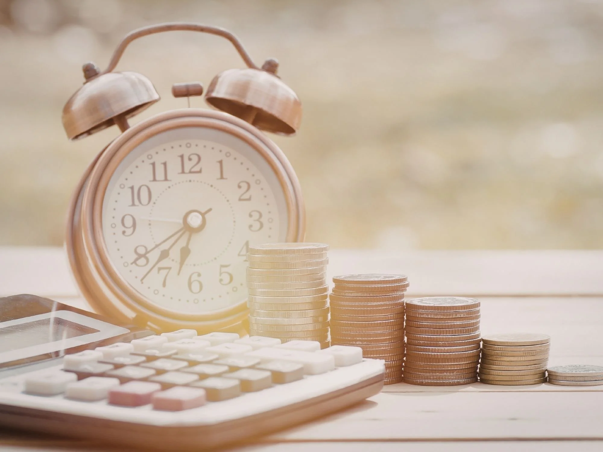 Alarm clock, coins, and a calculator