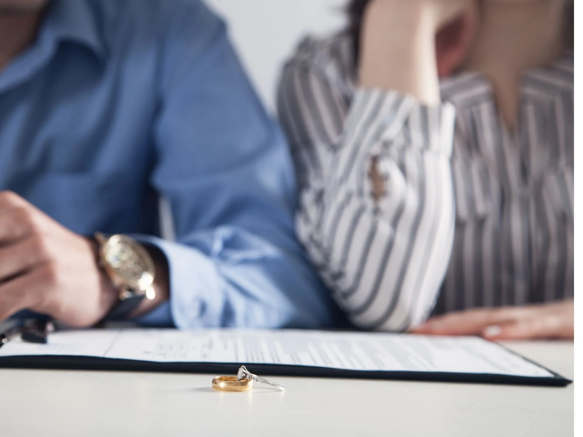 divorce papers sitting between two people - gray divorce Atlanta, GA